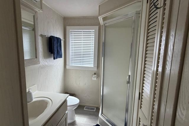 Bathroom interior of 1997 Stardust Houseboat 18x83 with shower and vanity.