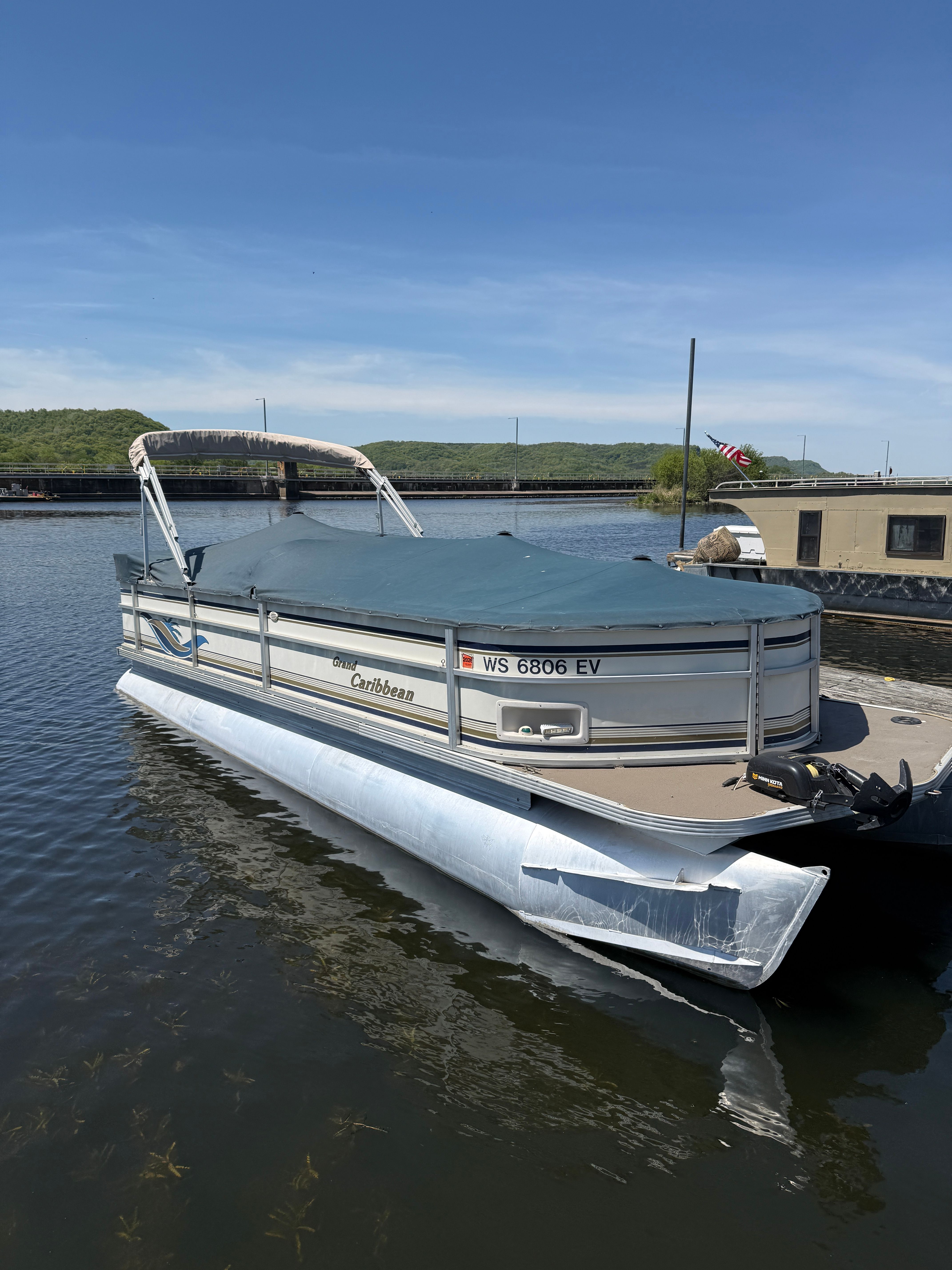 Crest Grand Caribbean pontoon boat from 2000 on the water.