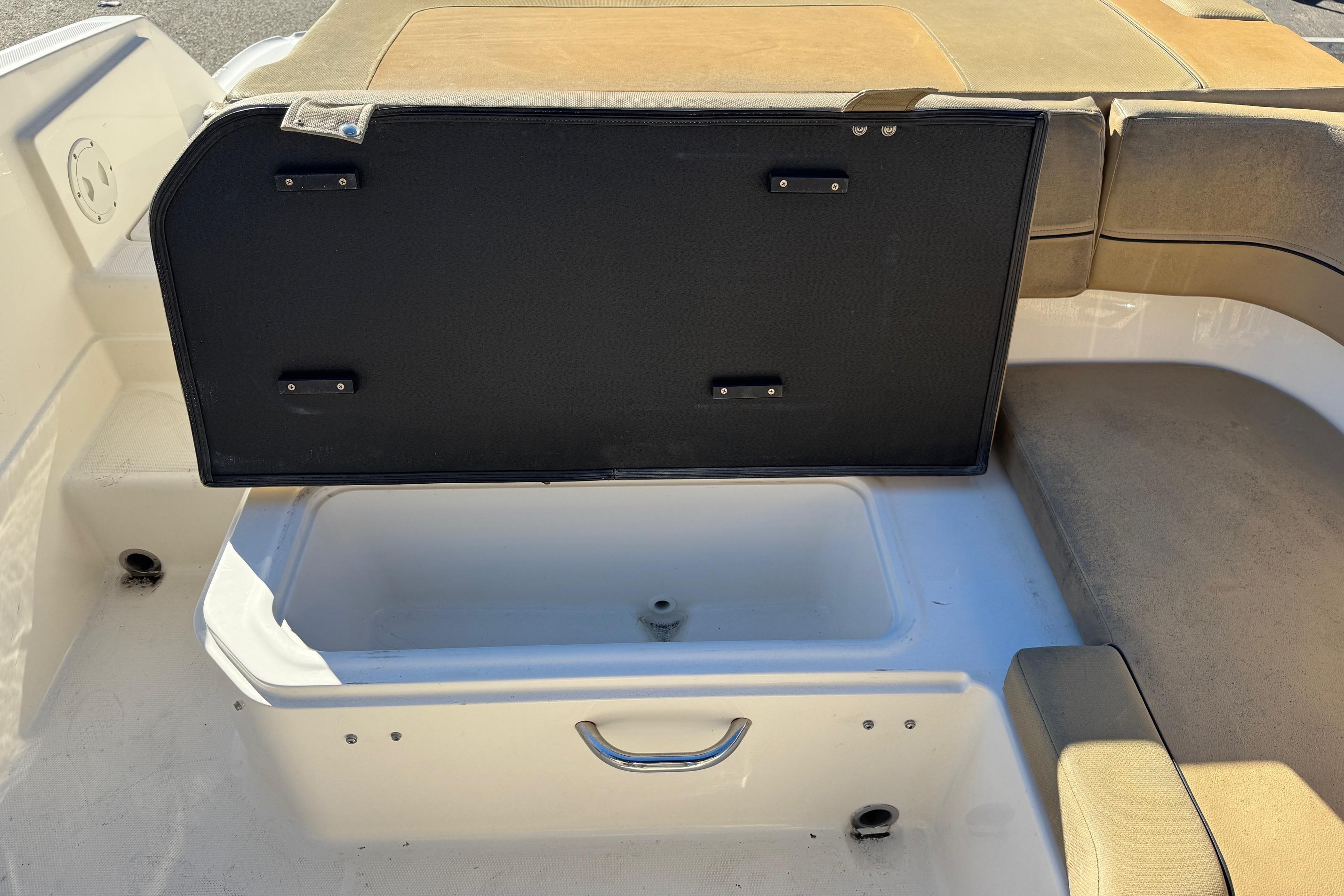 2022 Bayliner VR6 Bowrider OB storage compartment with open lid, showcasing interior space.