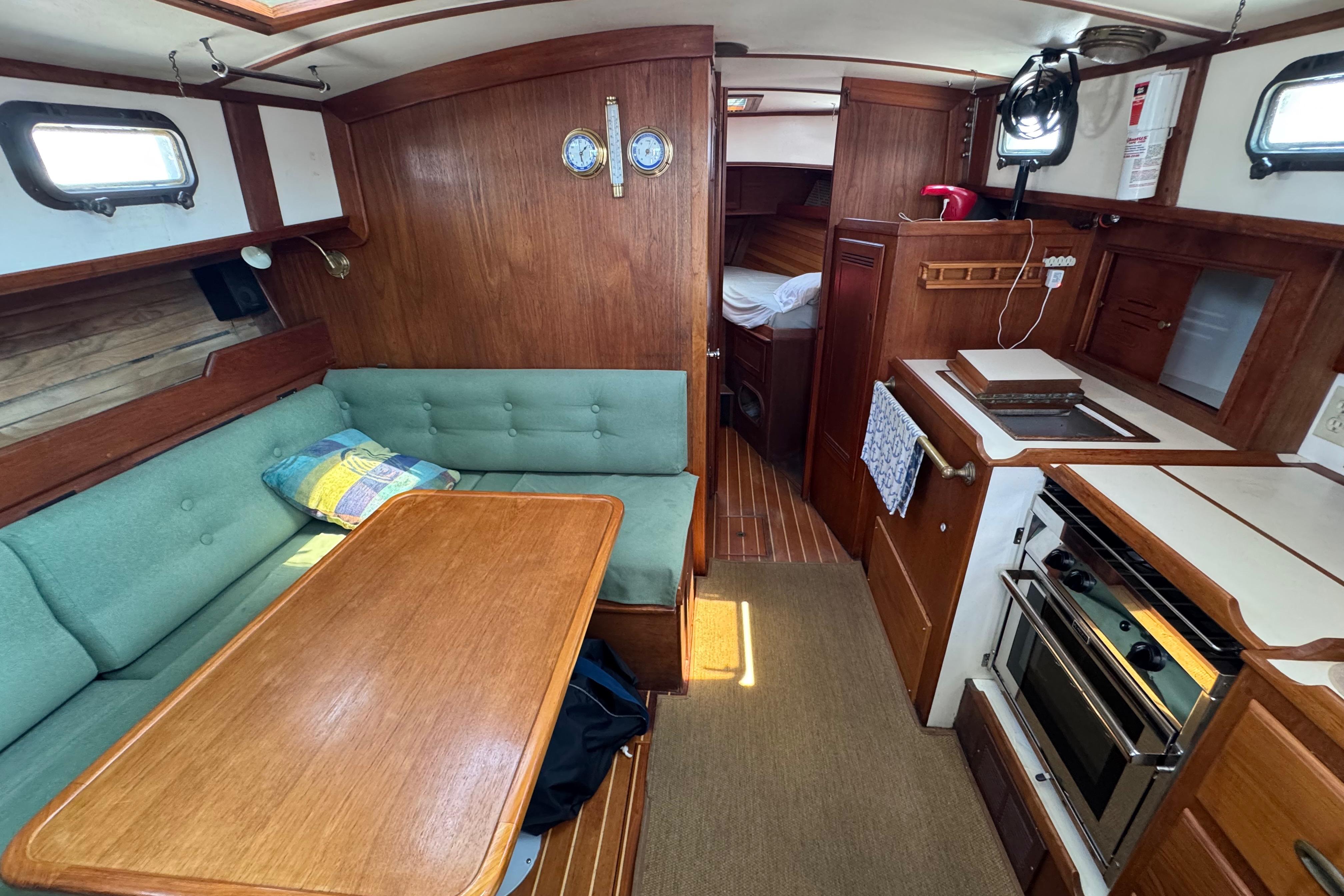 Interior of a 1989 Cape Dory 30 Motorsailer with wood finish and cozy seating area.