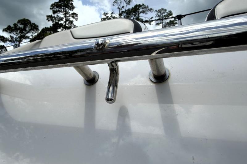 2017 Yamaha Boats SX210 chrome railing detail with cloudy sky background.