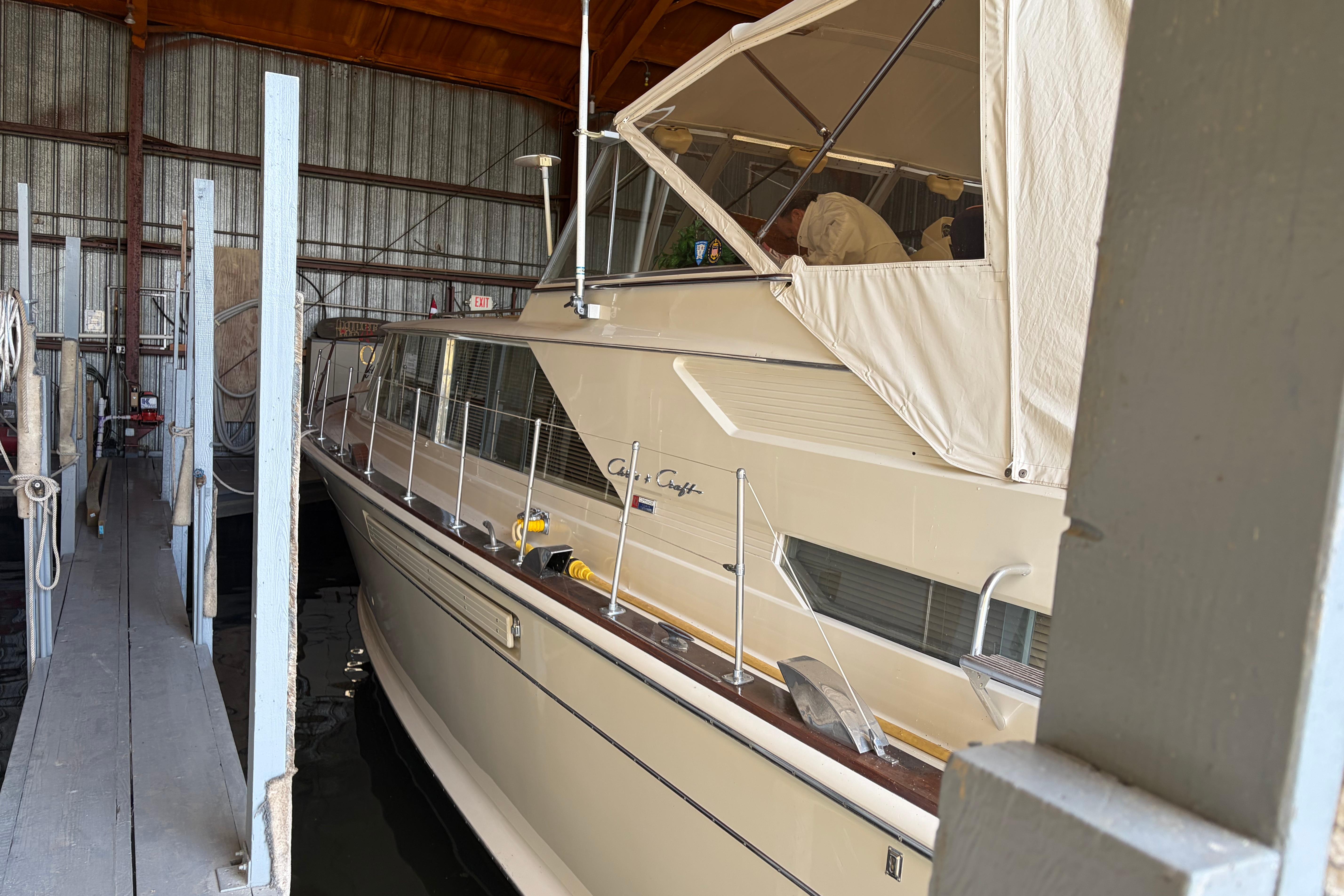 1971 Chris-Craft 42 Commander yacht docked in a covered marina.