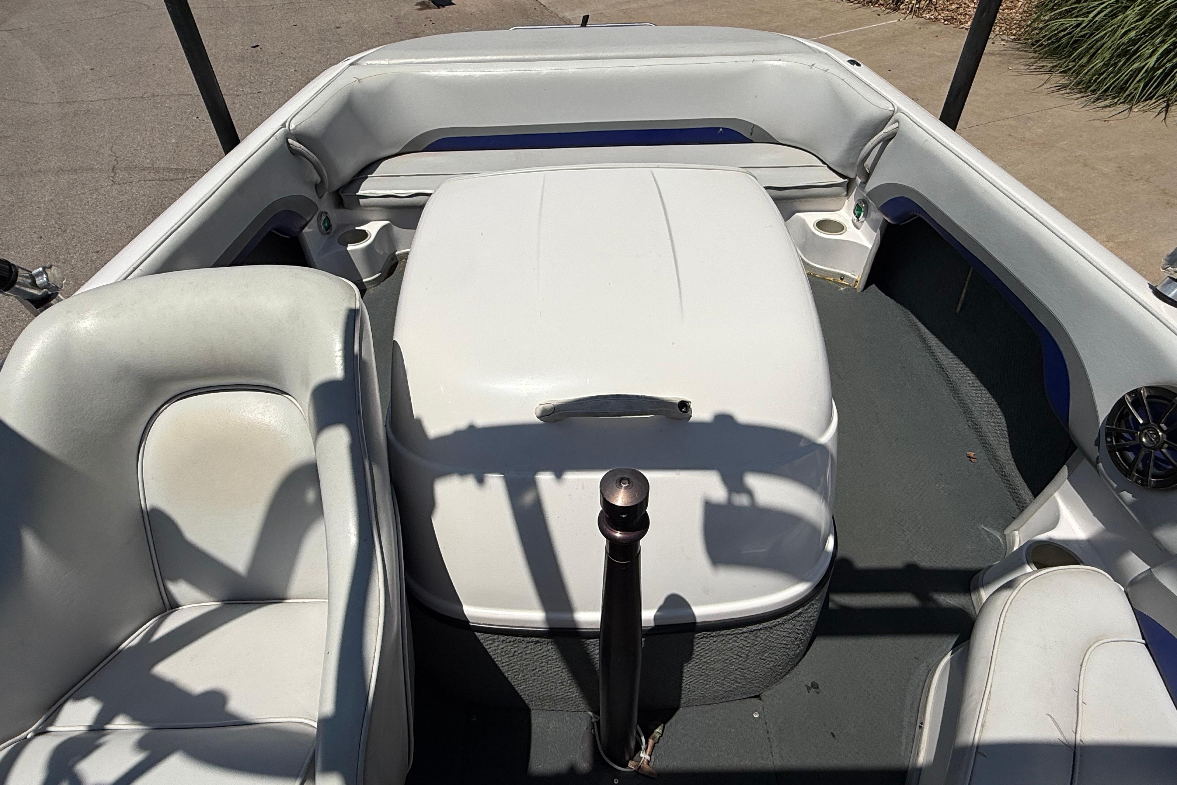 2001 Moomba Outback boat interior with white seating and central engine cover.