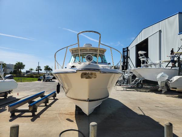2005 Pursuit 3070 Offshore Center Console boat in a marina, sunny day.