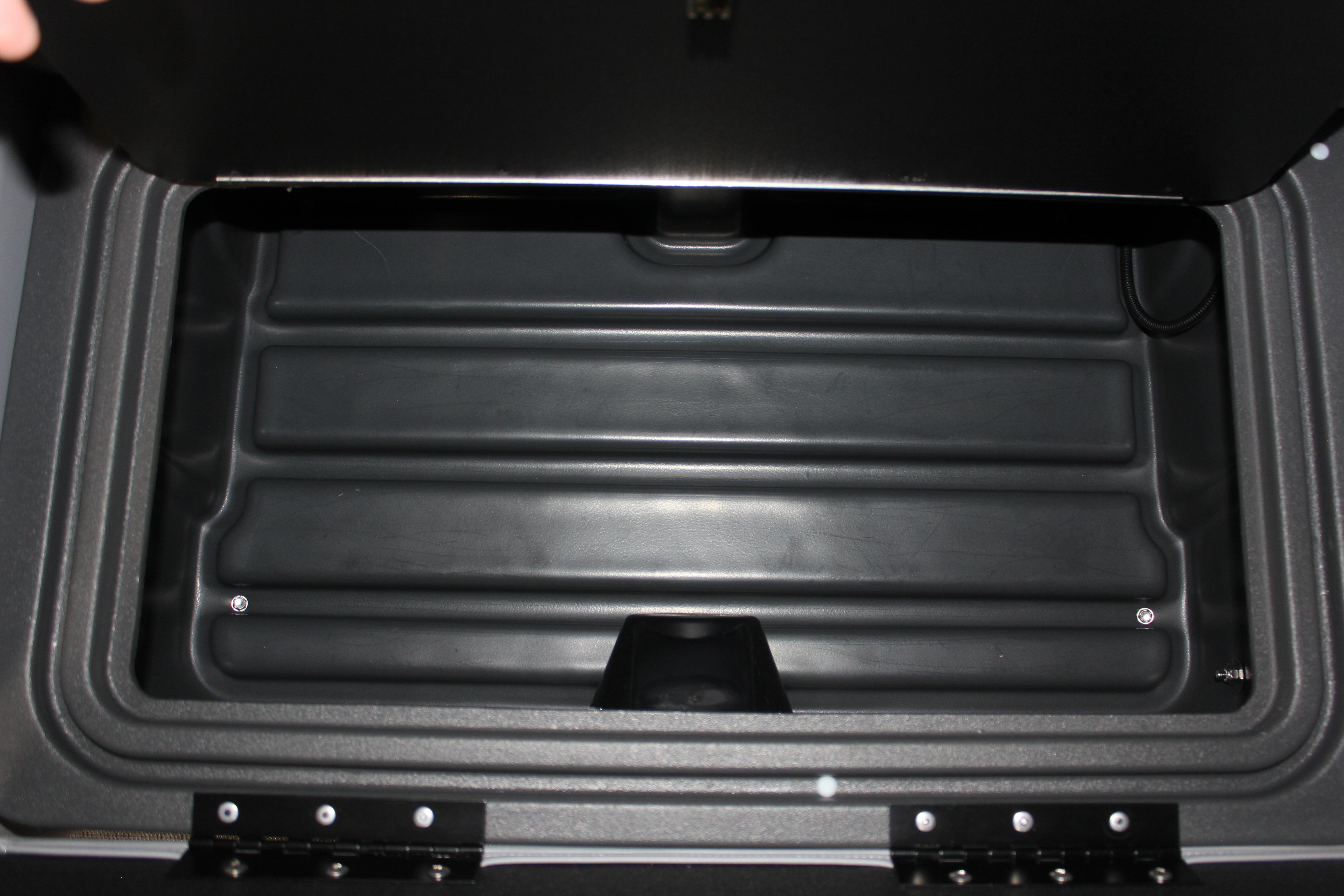 Storage compartment of 2026 Sun Tracker Party Barge 22 DLX, open and empty.