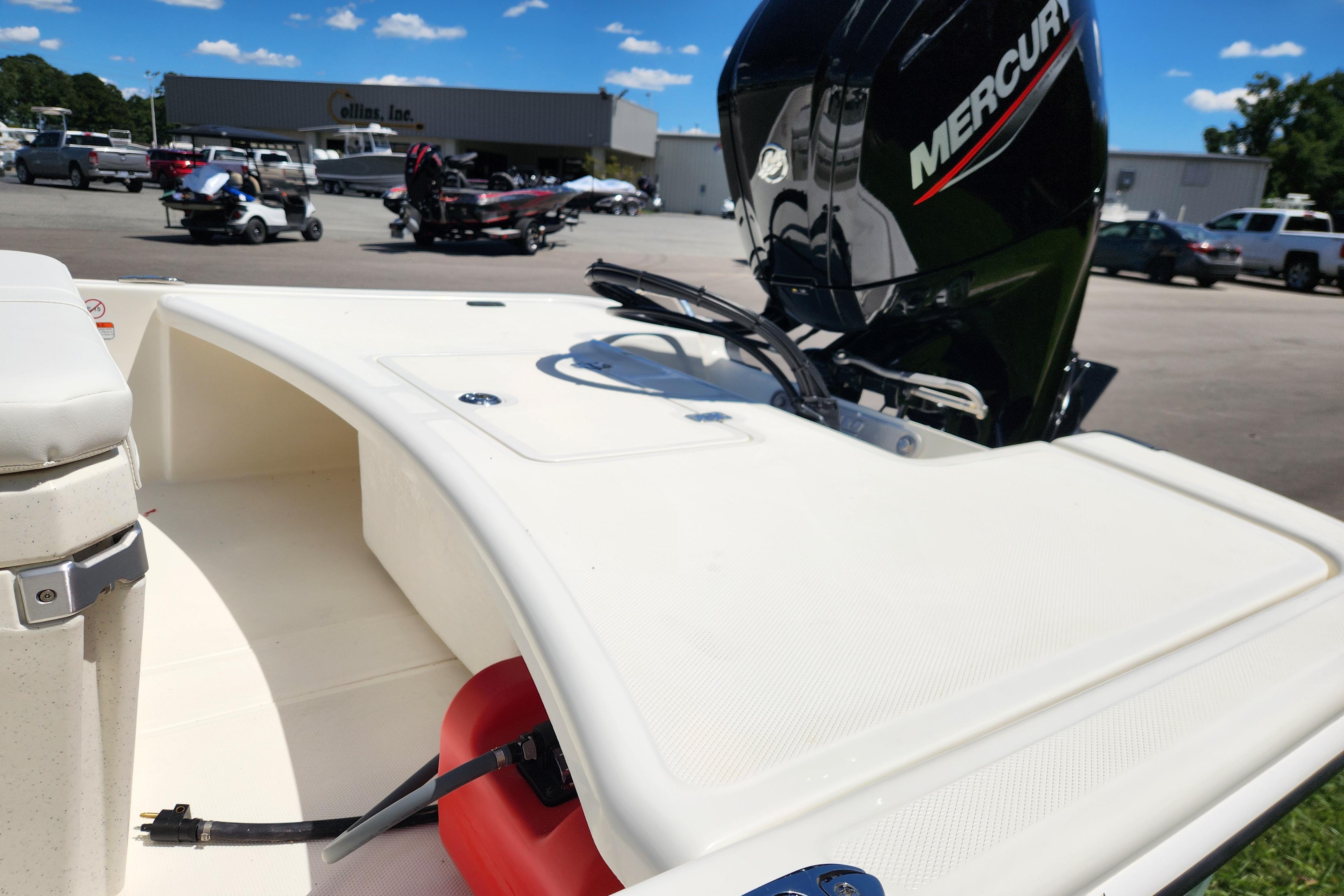 2026 Mako Pro Skiff 17 CC boat with Mercury engine in a dealership lot.