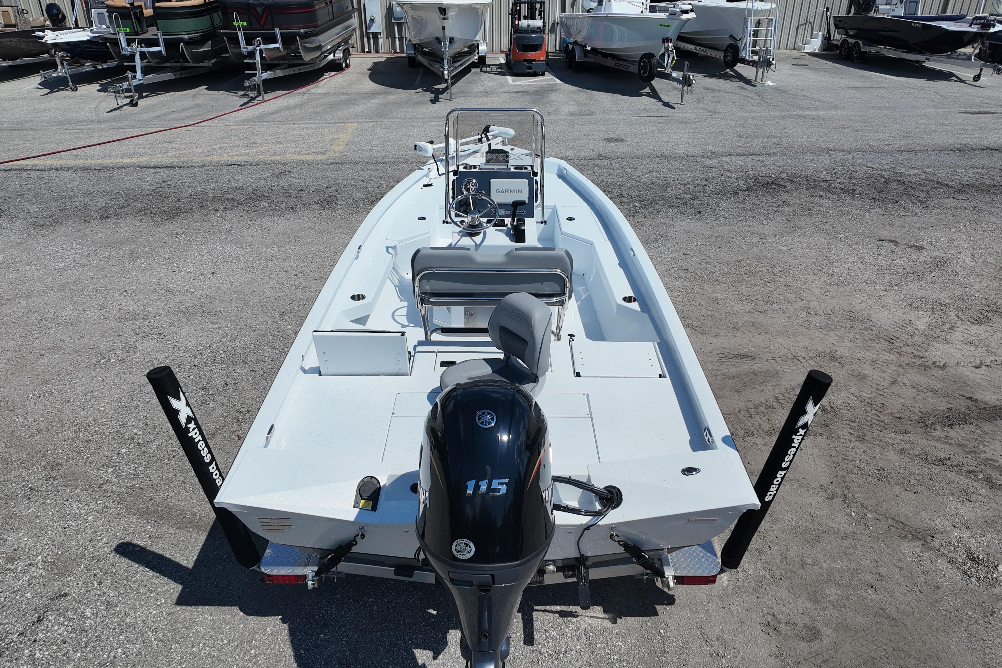 2026 Xpress H20 boat with Yamaha 115 engine, parked in a marina.