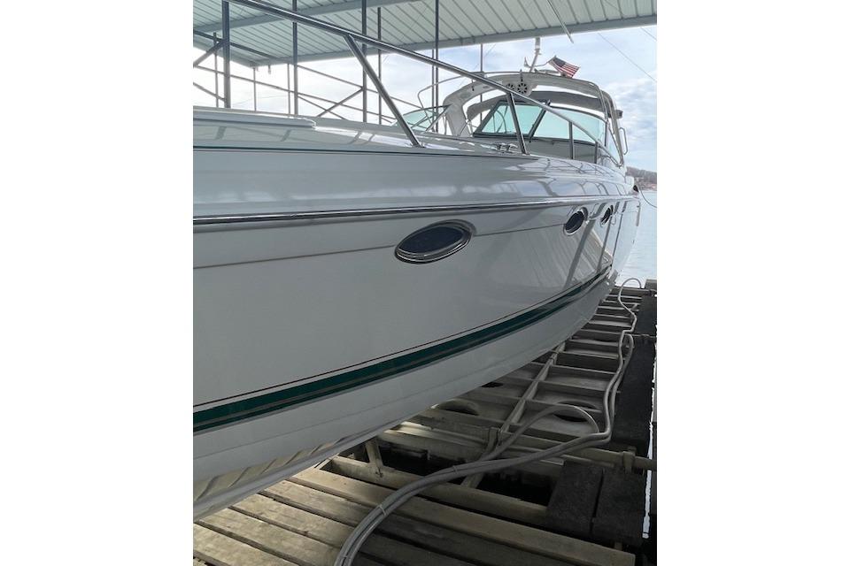 1999 Formula 400 Super Sport yacht docked, showcasing sleek white hull design.