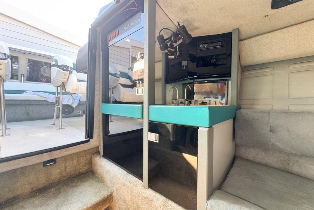 Interior of a 1989 Formula 292 SR-1 boat with seating and kitchenette.