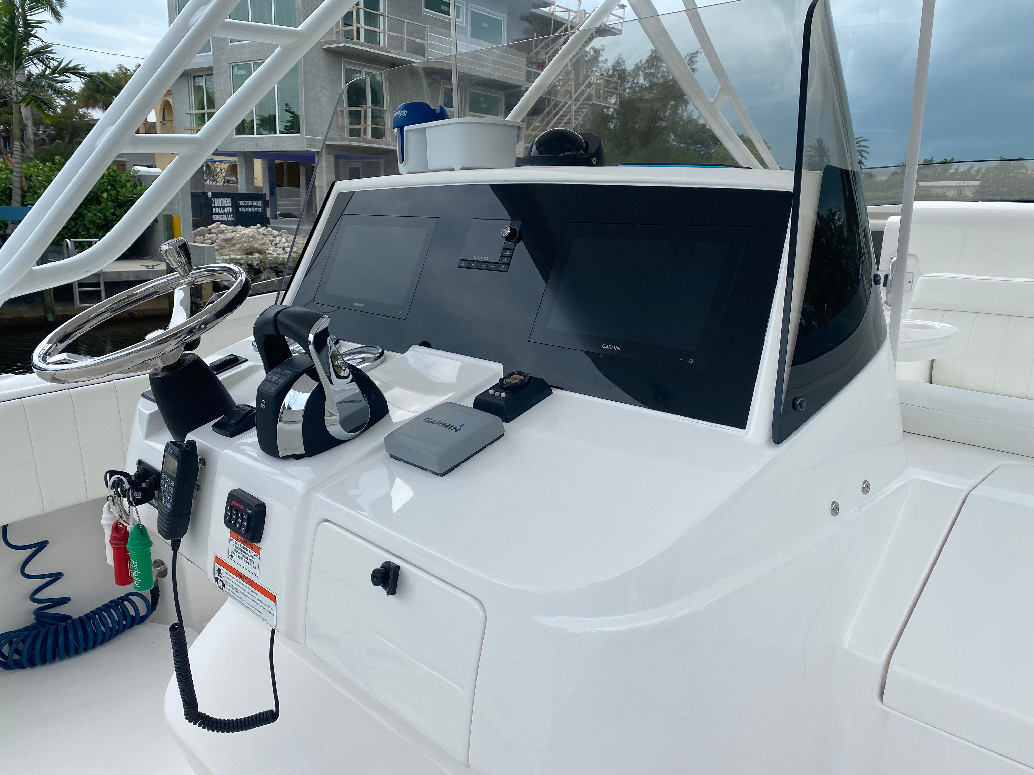 The image shows the helm of a 2011 Intrepid 37 boat with modern electronics.