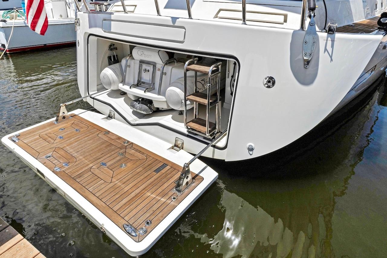 2011 Southerly 57 RS yacht with open swim platform and ladder in marina.