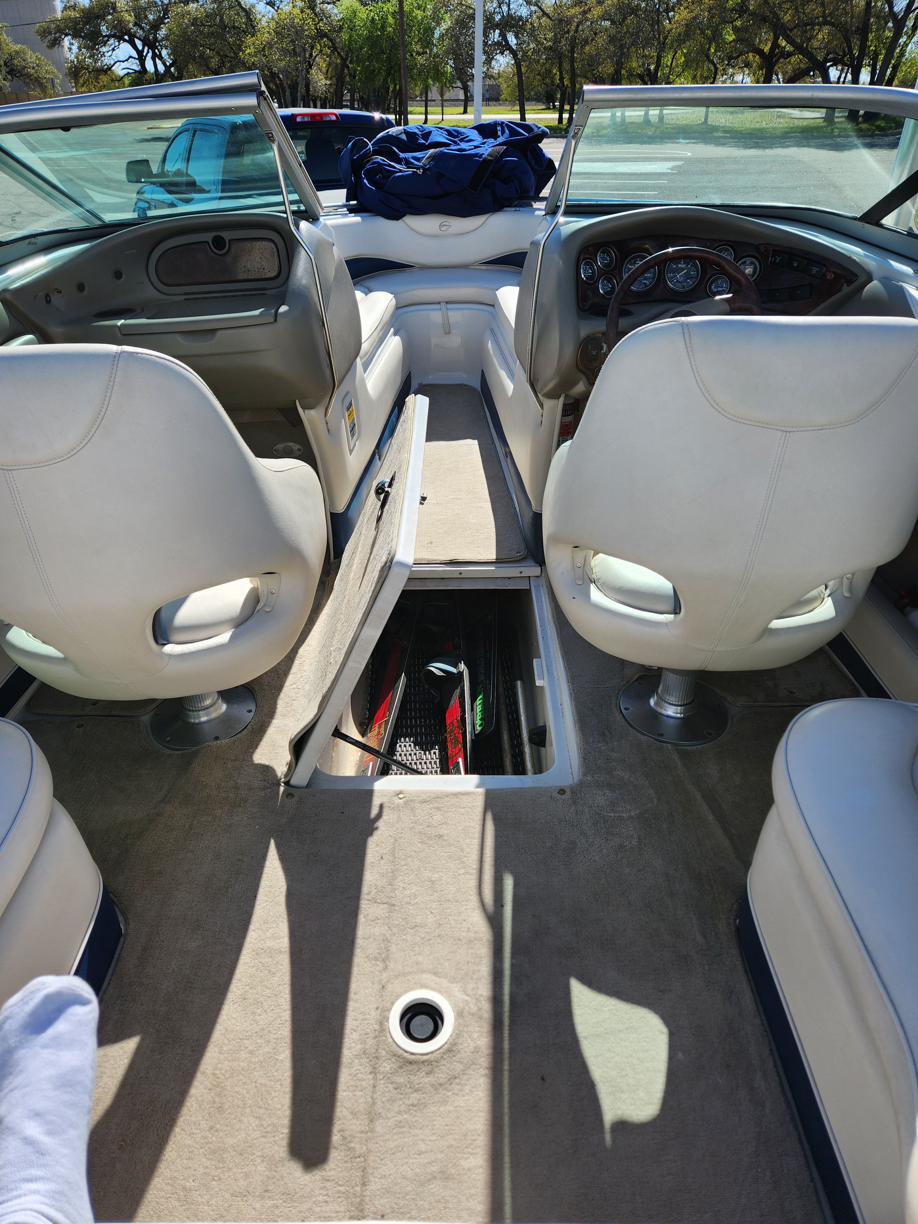 Interior of a 2003 Crownline 225 BR boat with white seats.