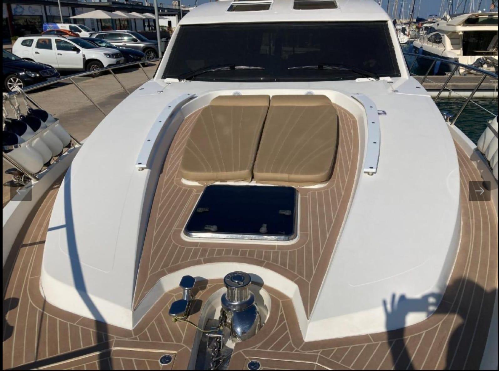 2005 Sealine T60 yacht with sunbathing area and sleek design at marina.