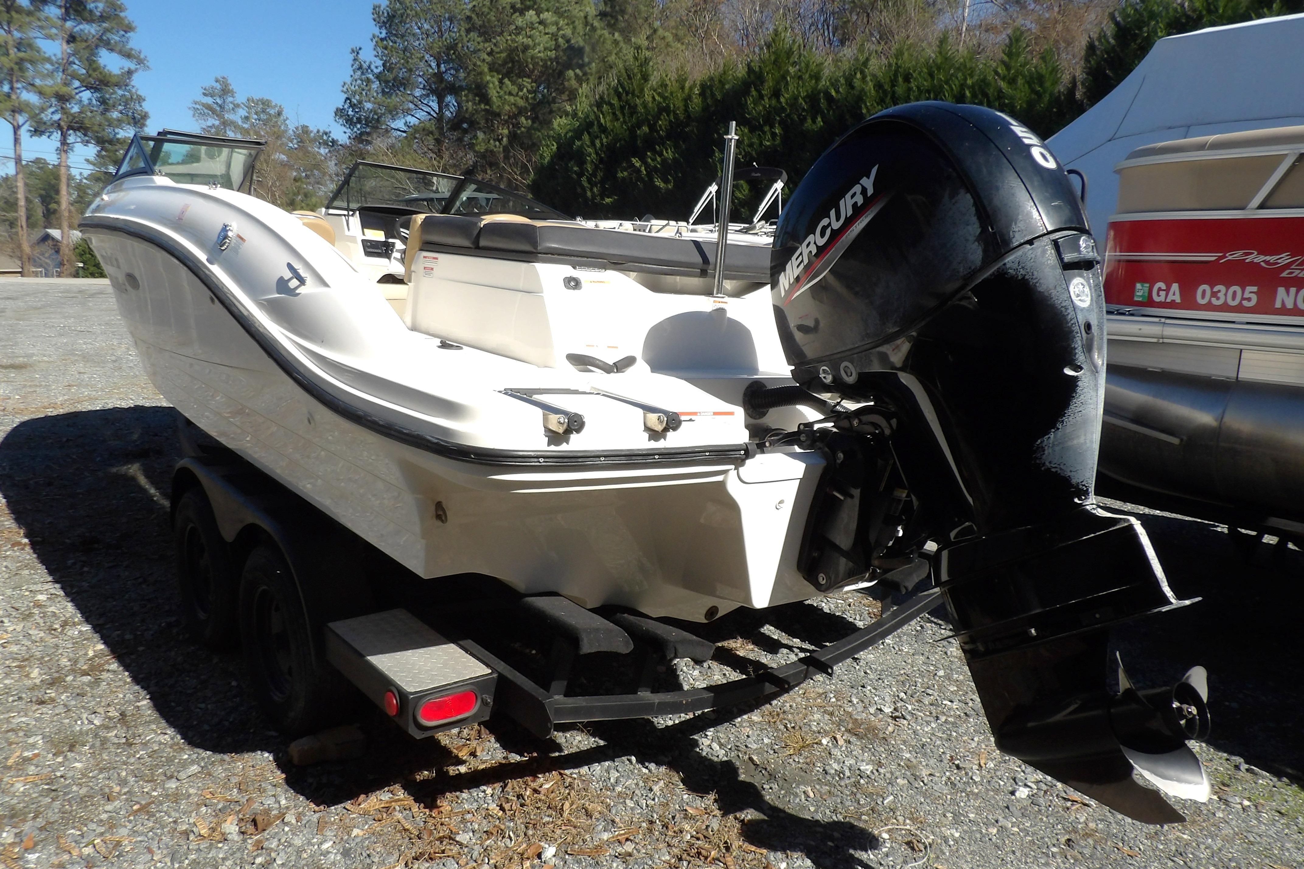 2023 Searay 210 SPO boat with Mercury outboard engine on trailer.