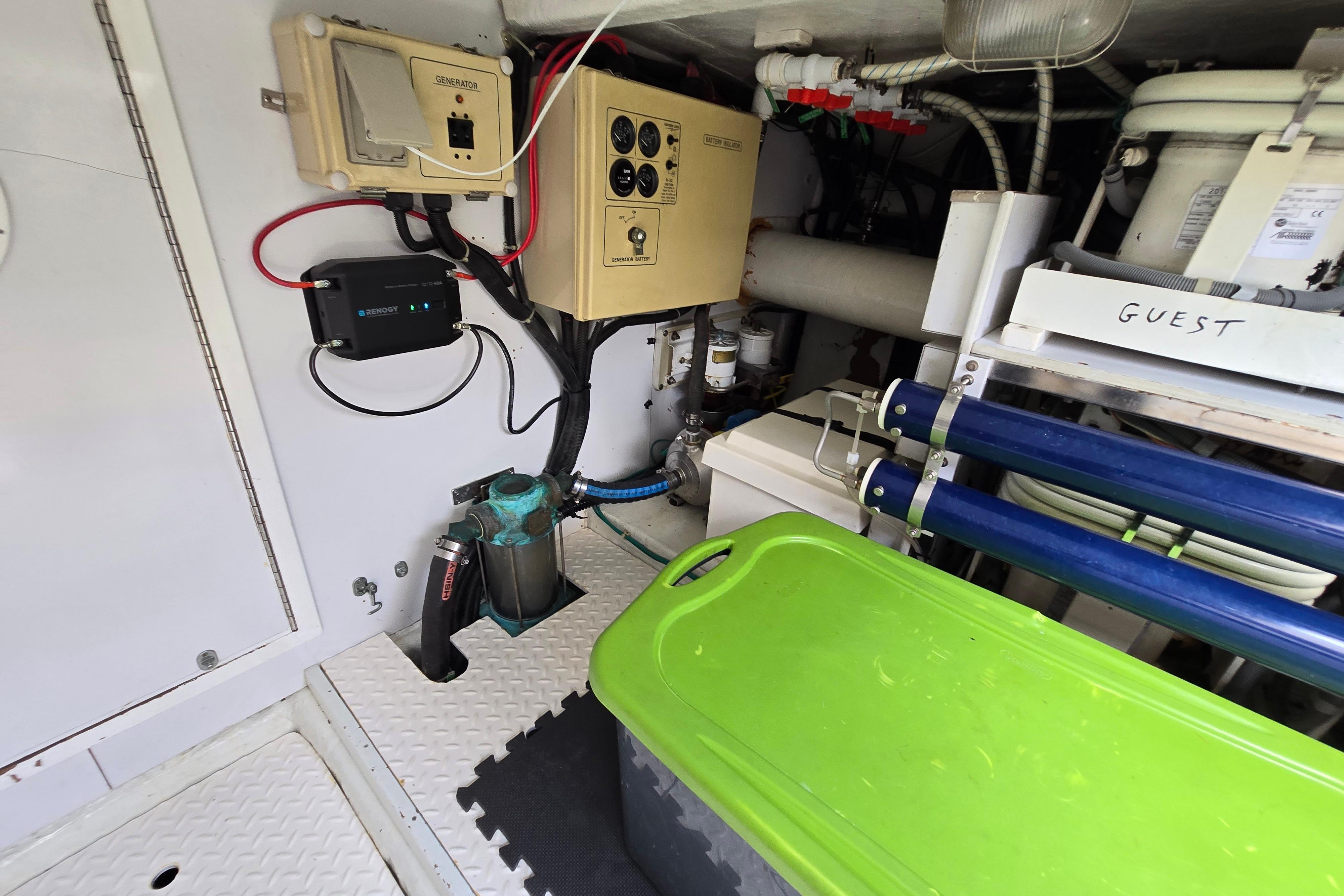 Engine room of a 2004 Grand Harbour 58 yacht with various equipment and storage.