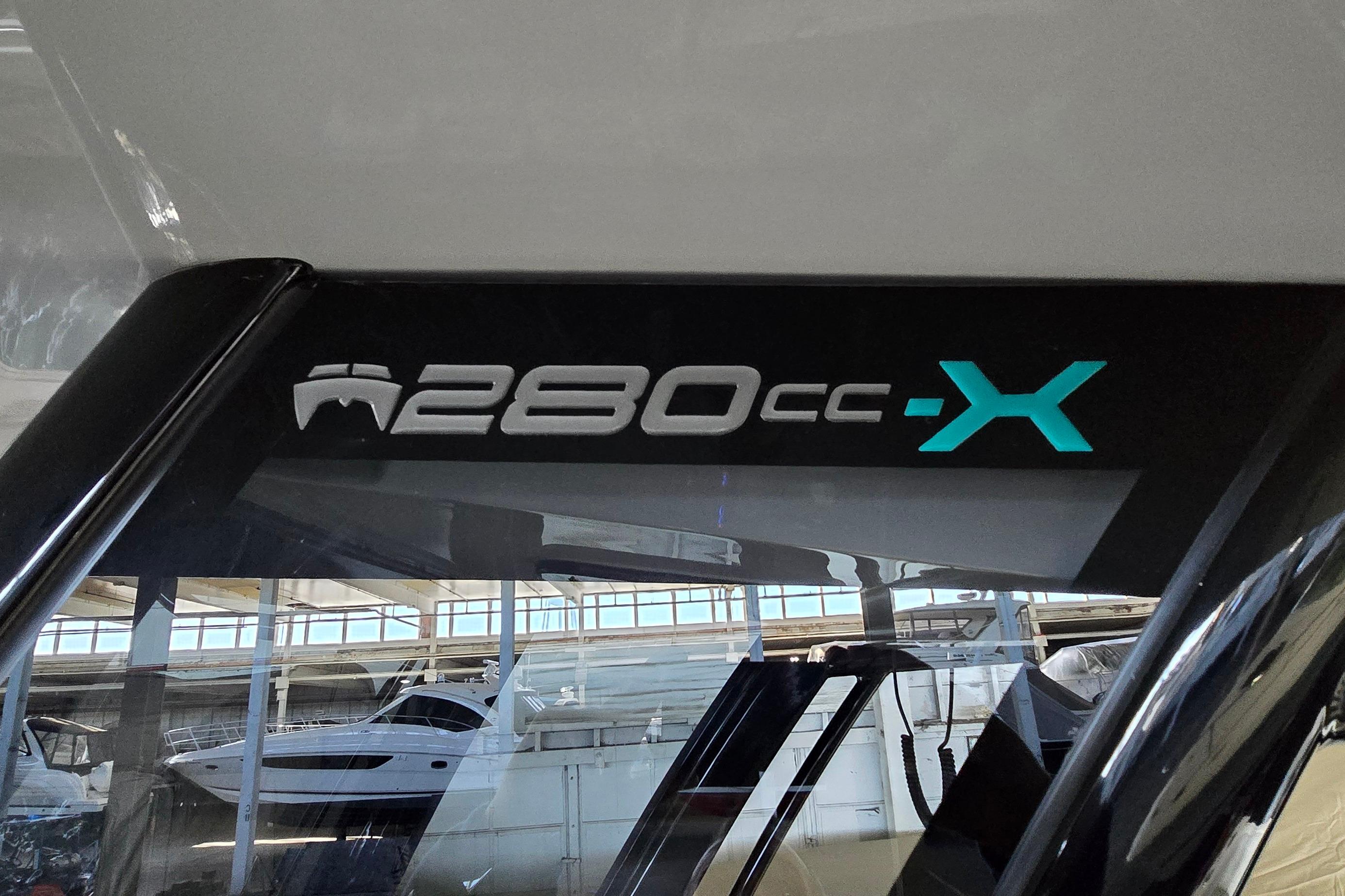 2024 WorldCat 280 CC-X boat logo in a showroom setting.
