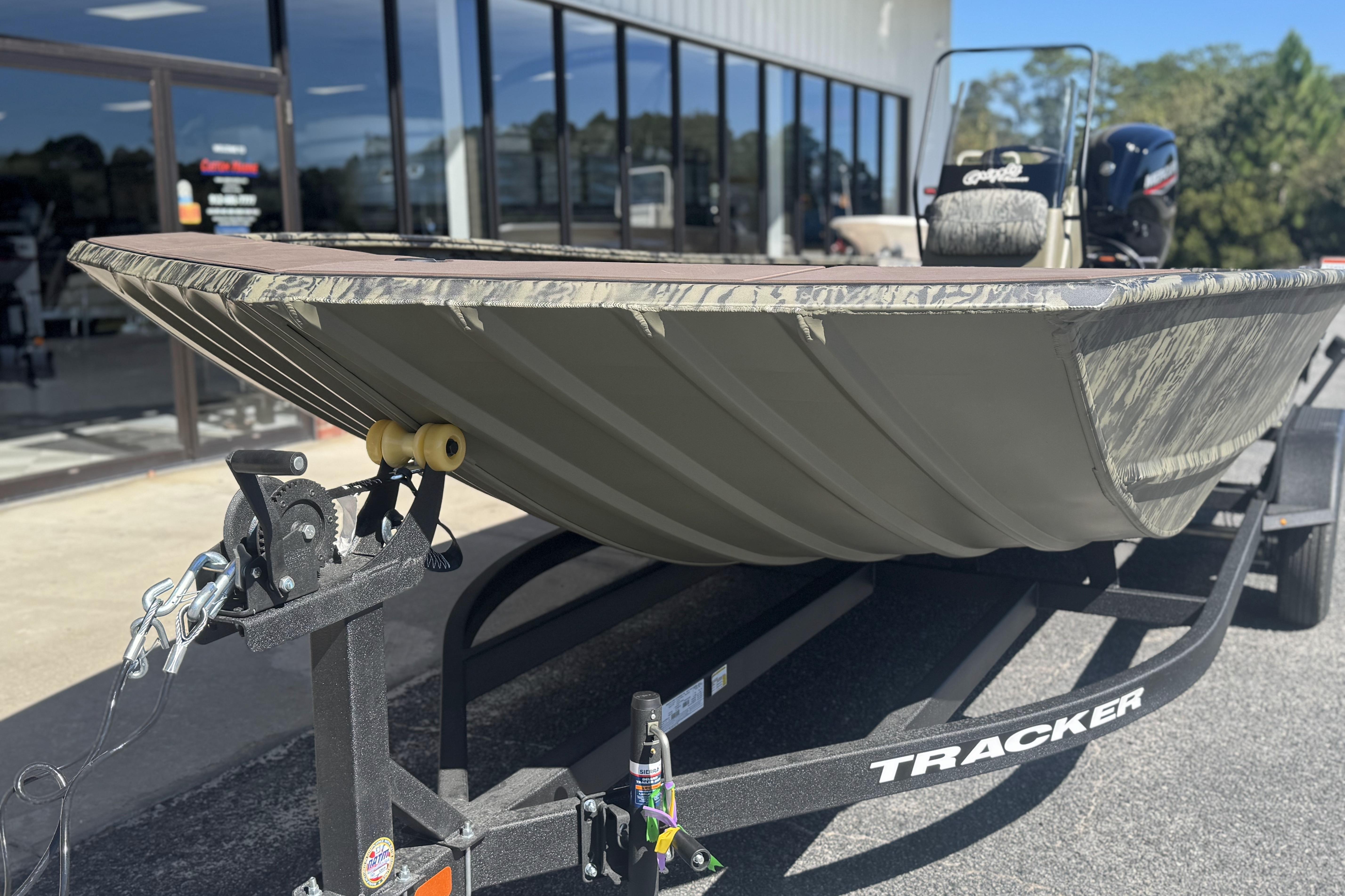 2026 Tracker Grizzly 2072 CC boat on trailer outside dealership.
