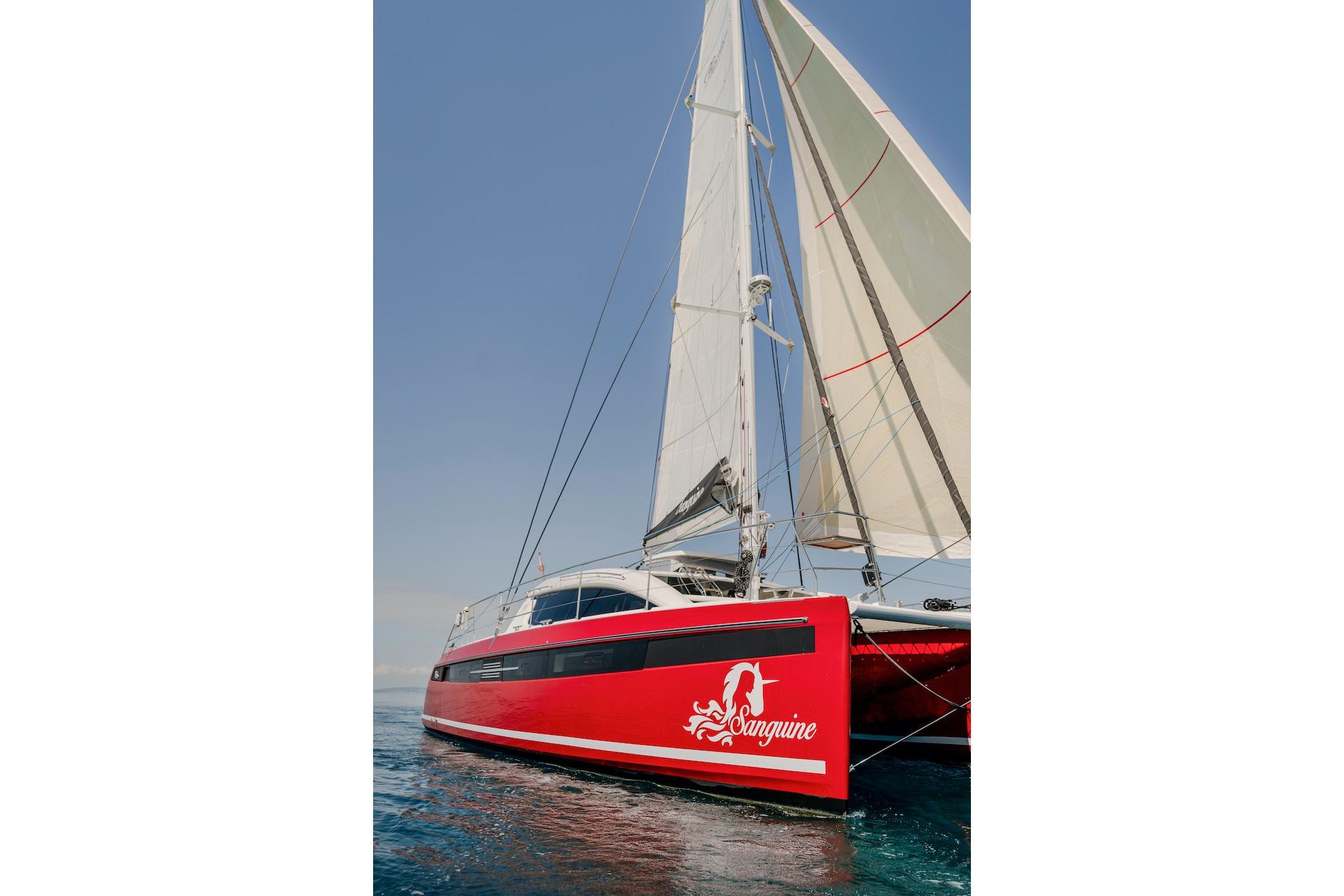 Red Privilege Signature 510 catamaran, 2025 model, sailing on open sea.
