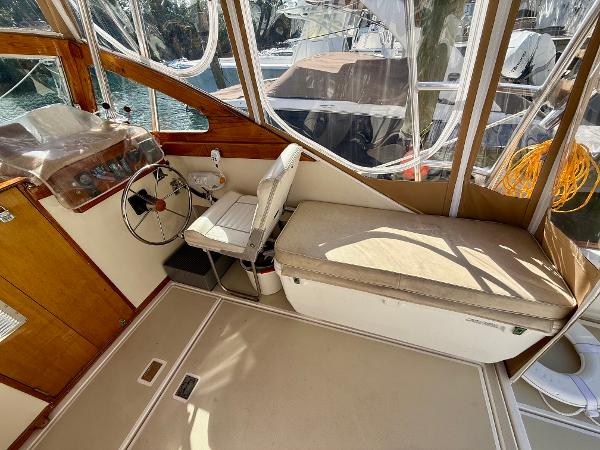 1978 Dyer 29 Trunk Cabin interior with steering wheel and seating area.