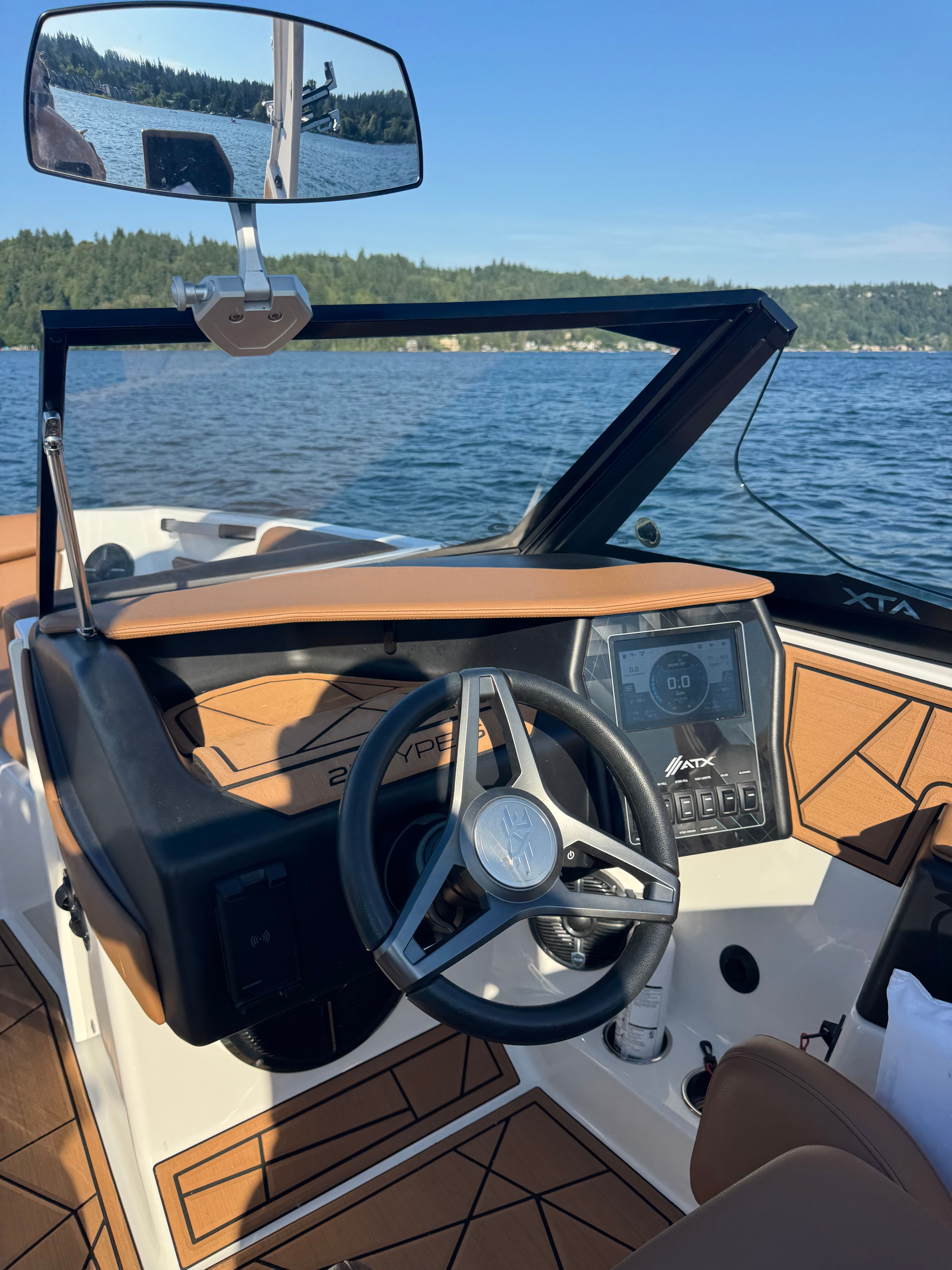 The cockpit of a 2022 ATX Surf Boats 22 Type-S with a modern steering wheel and dashboard.