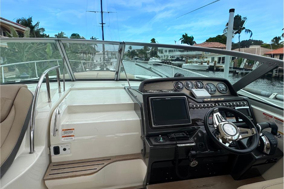 2016 Sea Ray 350 Sundancer helm with modern controls and waterfront view.