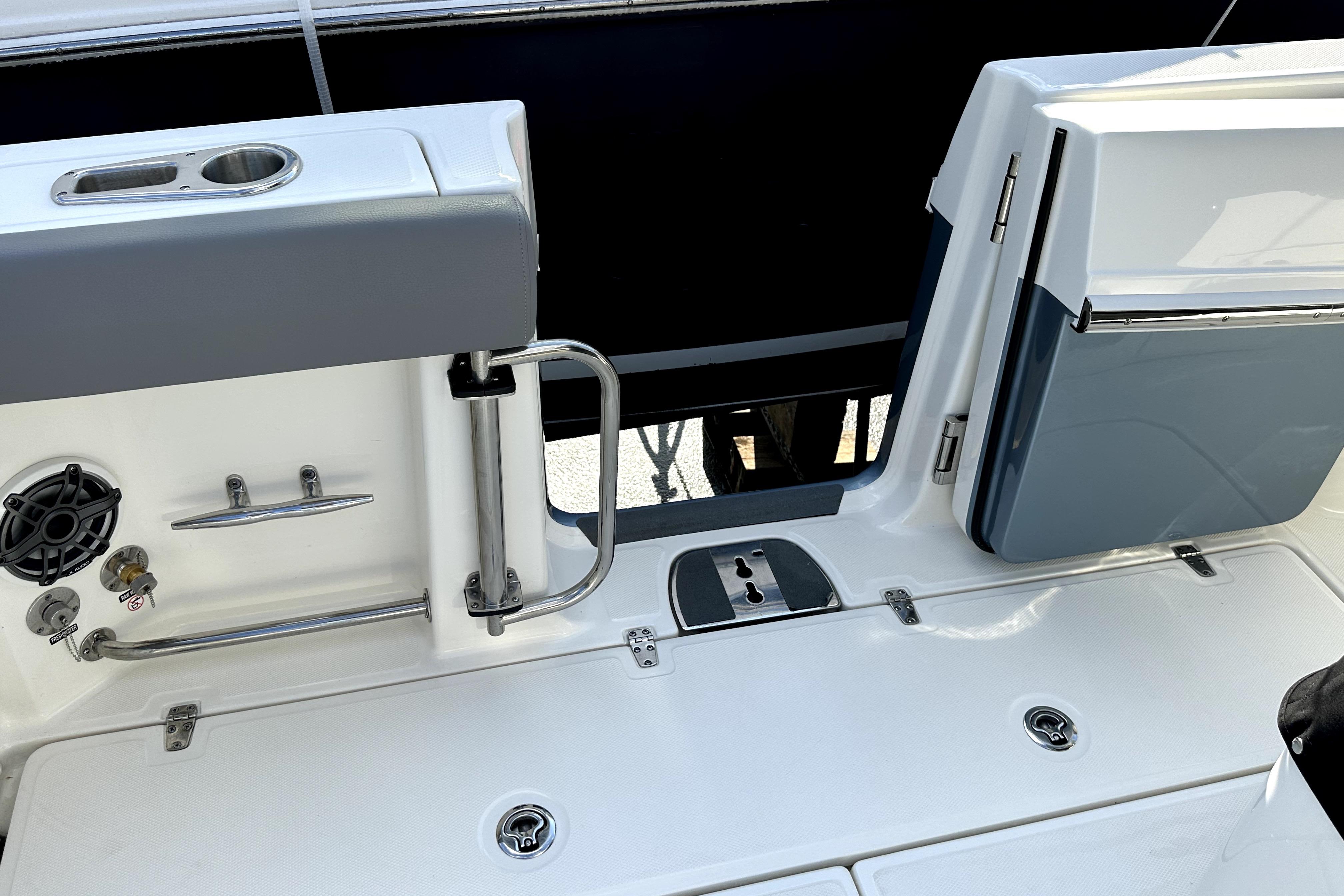 2023 Boston Whaler OUTRAGE boat deck with storage and stainless steel fixtures.