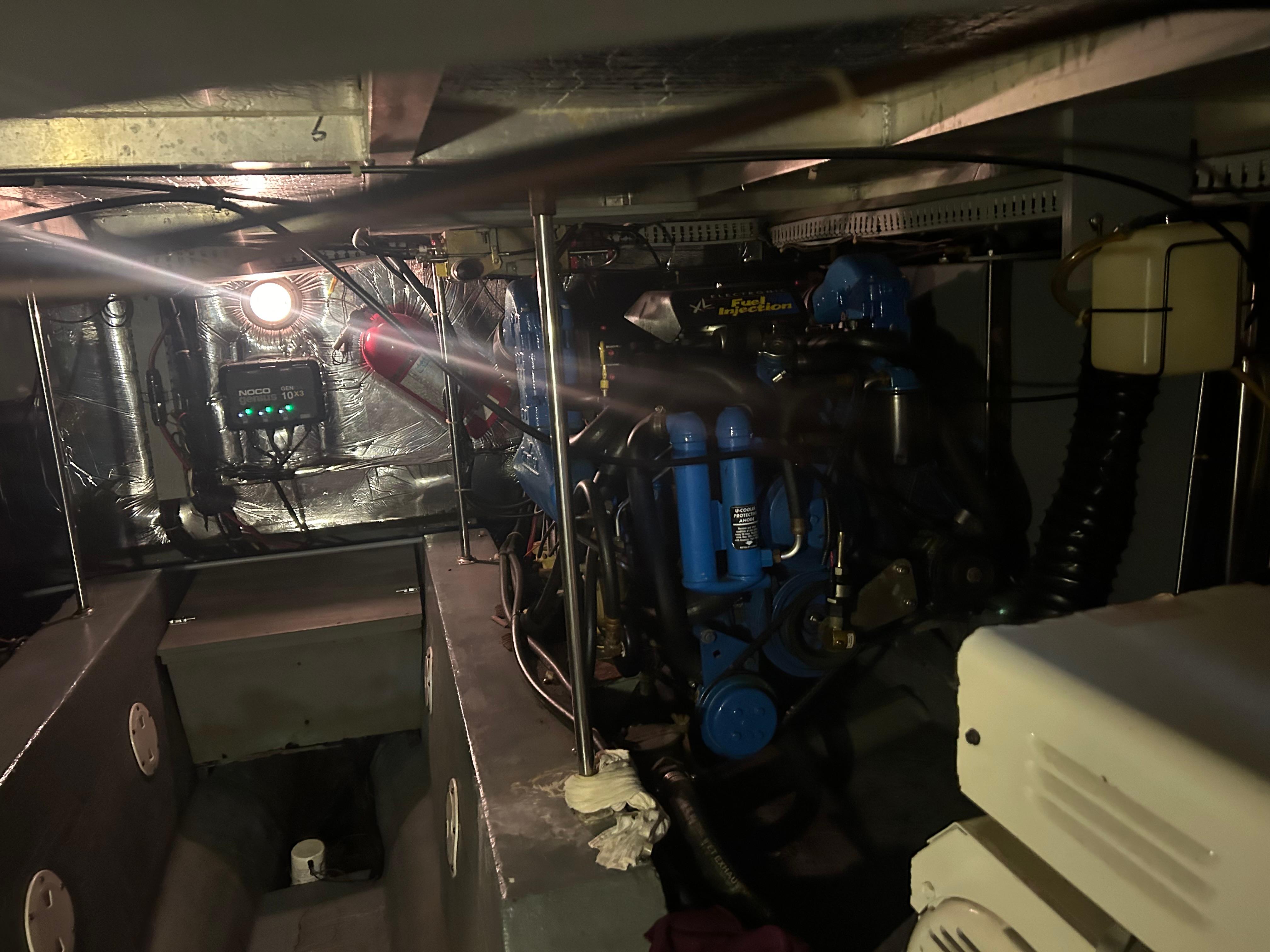 Engine room of a 1996 Carver 440 Aft Cabin Motor Yacht, featuring mechanical components.