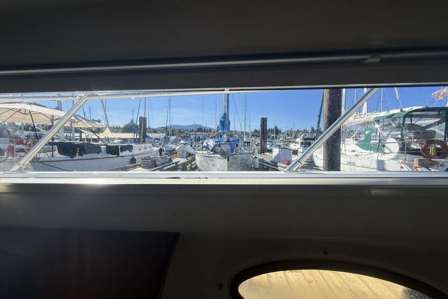 View from Royal Pacific 476 Sport Cruiser, 2000, overlooking marina with sailboats.