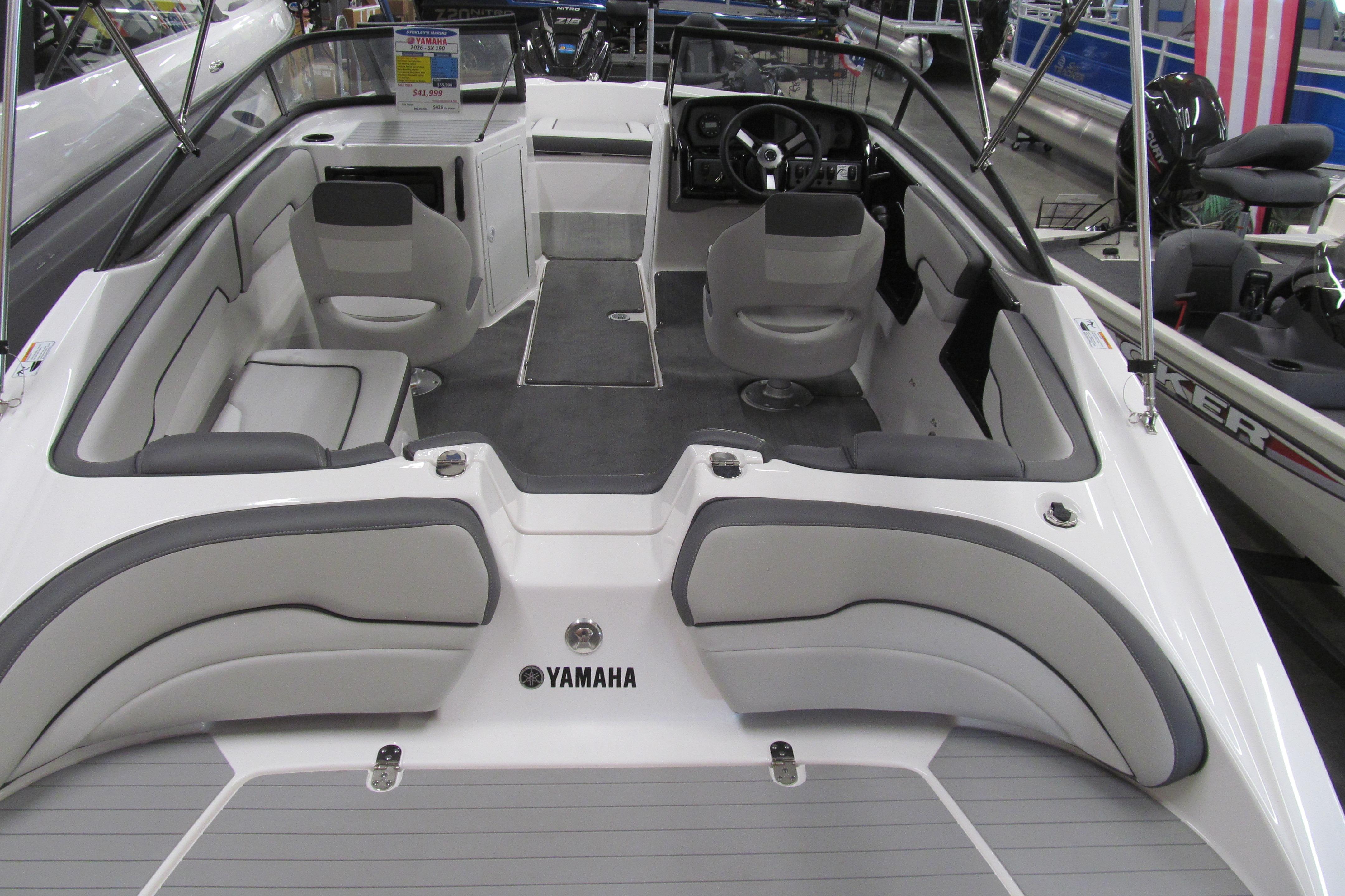 2026 Yamaha Boats SX190 interior with seating and steering wheel, showcased at a boat exhibition.