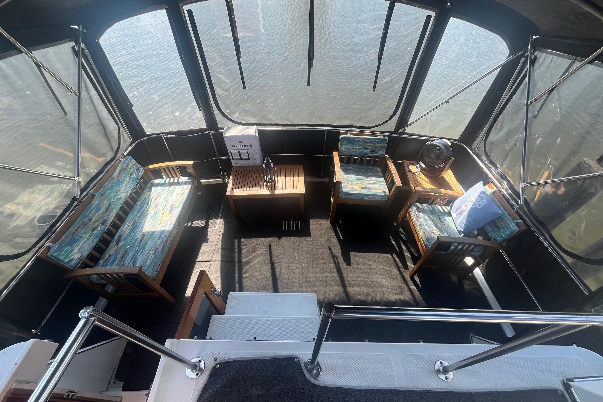 Interior of 1990 Cooper Prowler 35 boat with seating and water view.