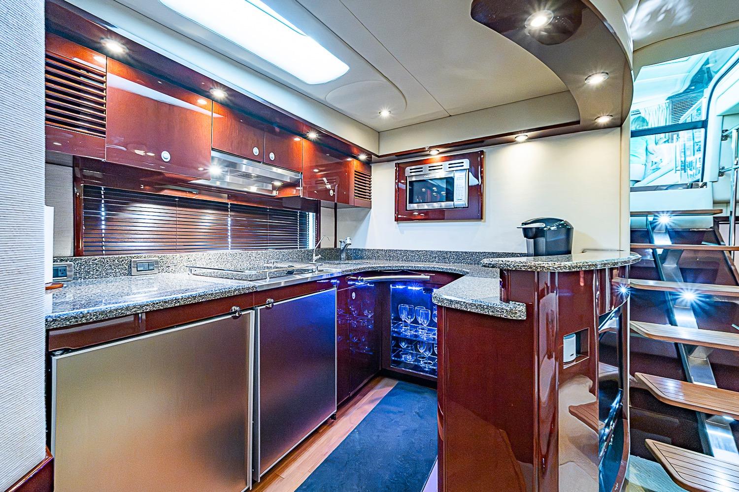 Luxurious 2008 Sea Ray 60 Sundancer yacht kitchen with modern amenities and elegant wood finishes.