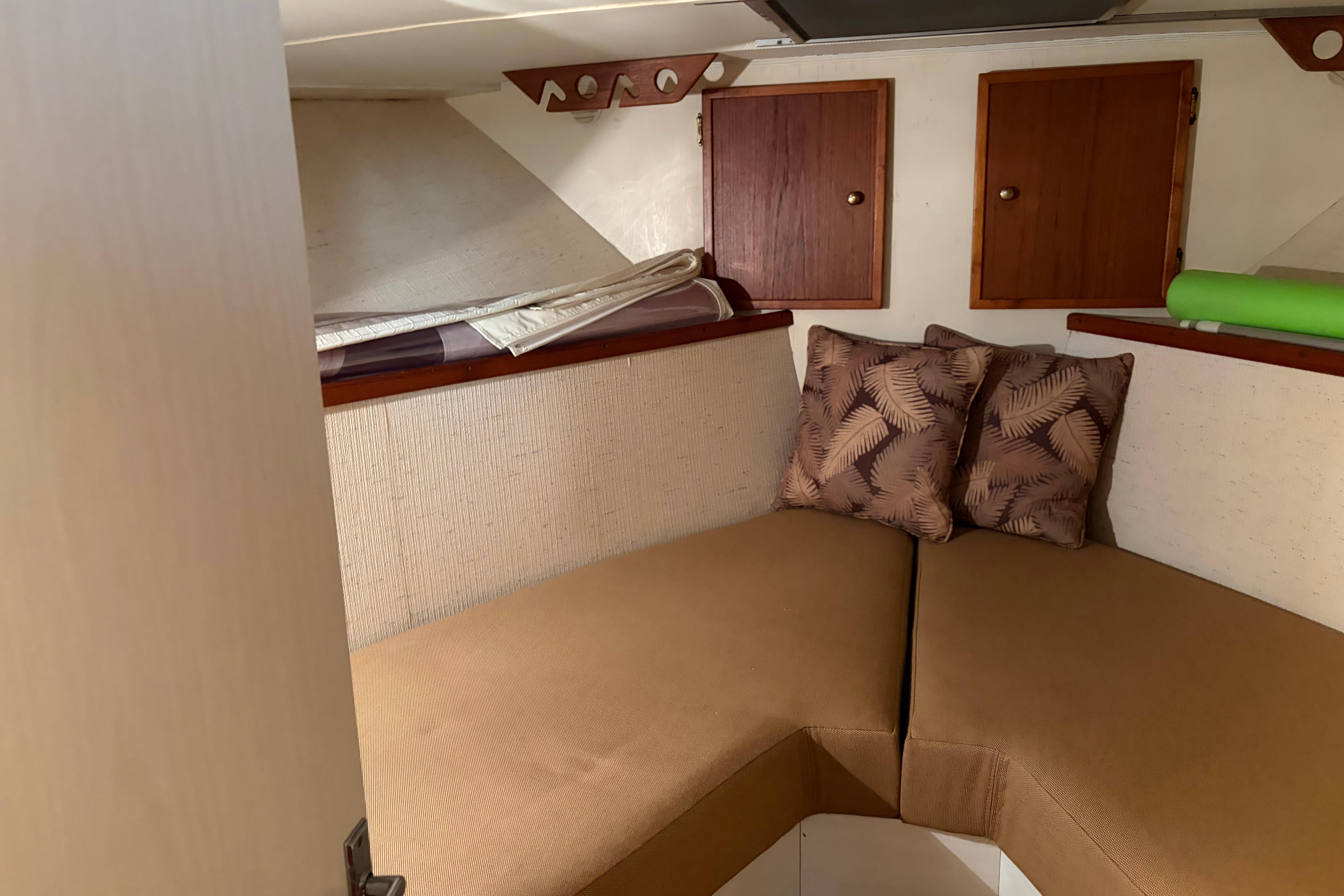 1971 Chris-Craft 42 Commander cabin interior with cozy seating and decorative pillows.