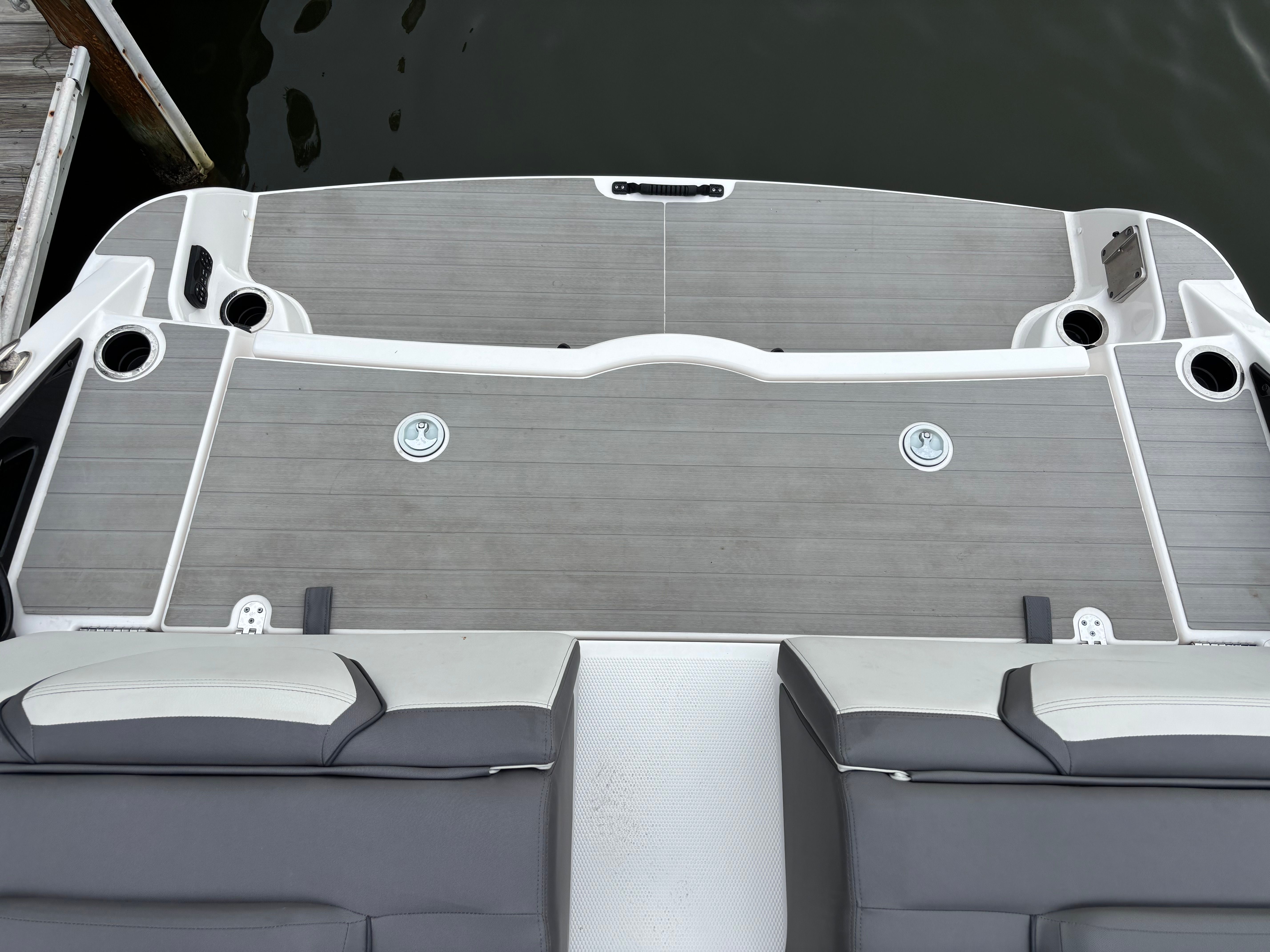 The image shows the stern of a Yamaha AR250 boat by the water.