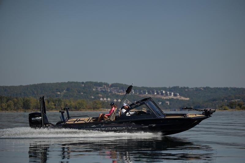 2026 SeaArk Dynasty 2.0 boat cruising on a calm lake with scenic background.
