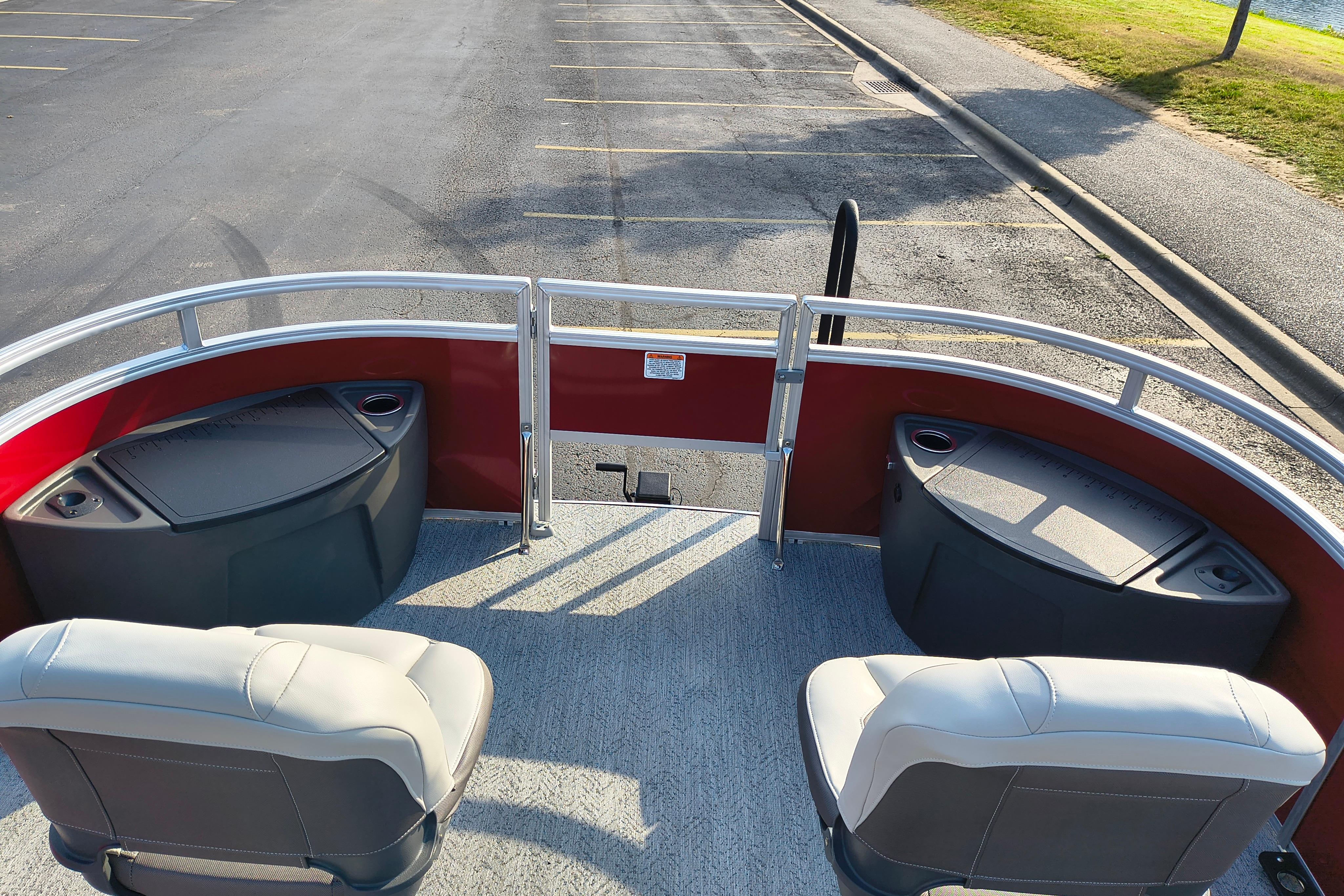 2026 Sun Tracker Fishin' Barge 22 DLX interior with seating and storage compartments.