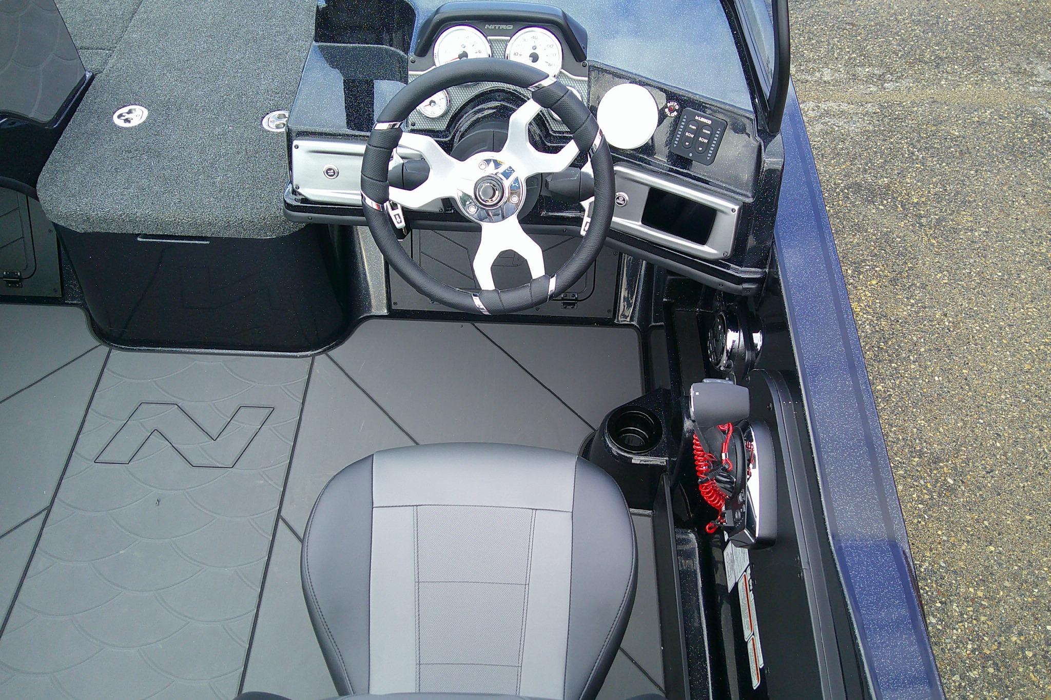 Interior view of a 2026 Nitro ZV20 boat, featuring steering wheel and dashboard controls.