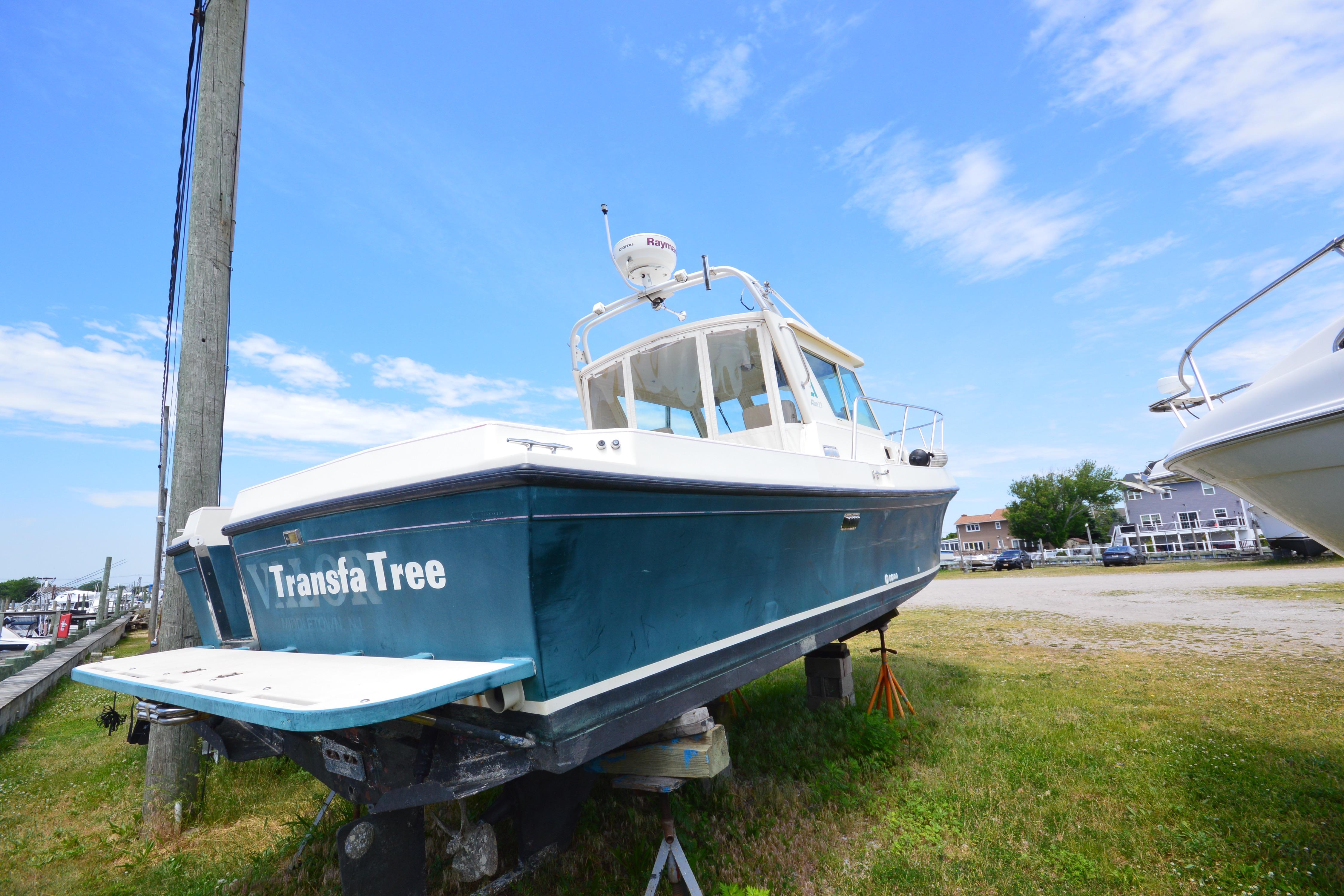 2001 Albin 28 Tournament Express boat on land, blue hull, clear sky background.