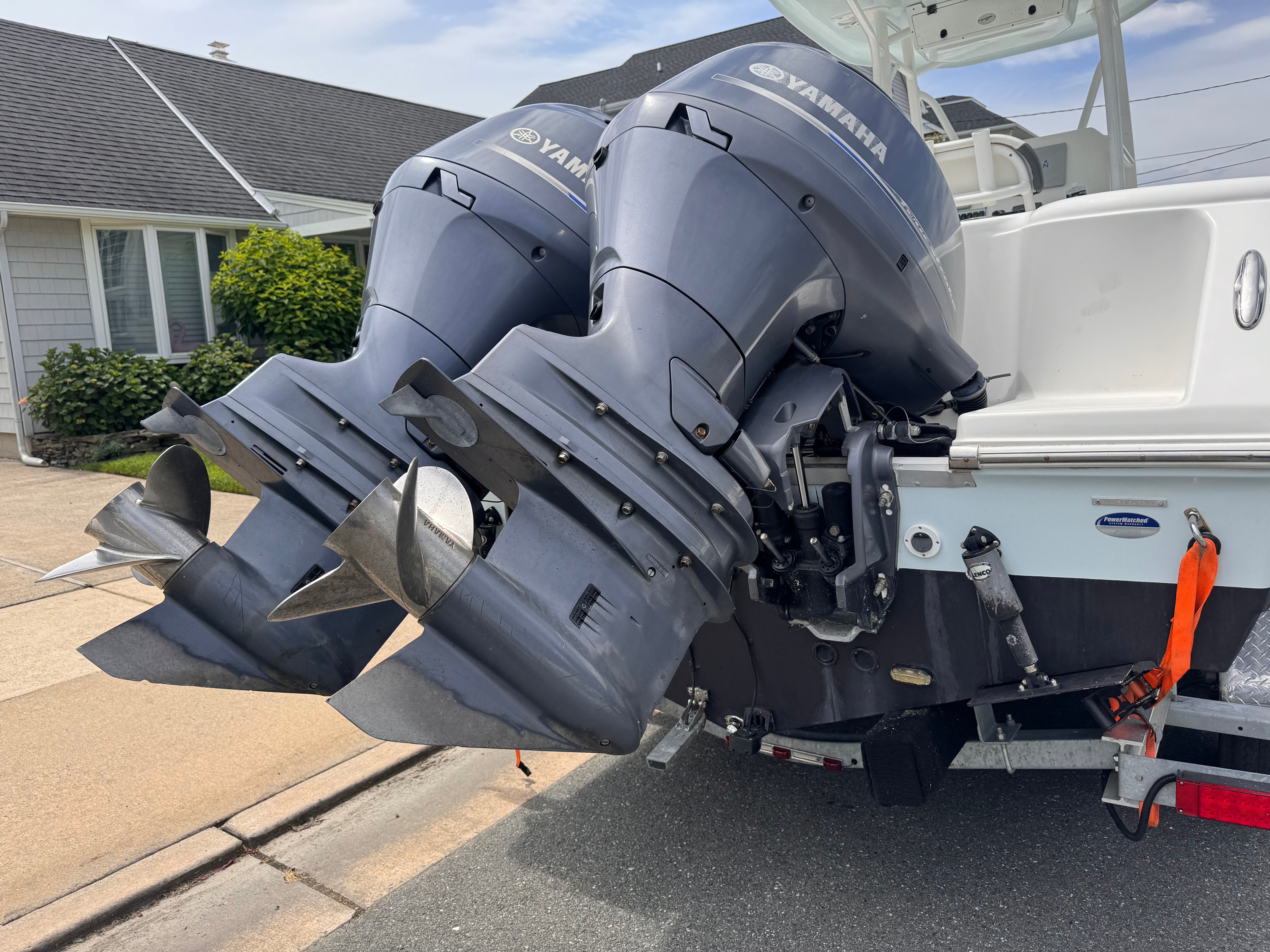 Two Yamaha outboard engines are mounted on the stern of a boat on a trailer.