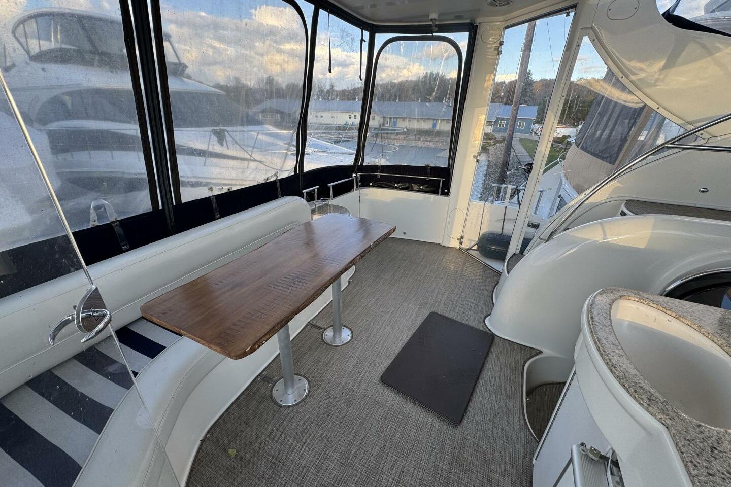 2008 Meridian 459 Motoryacht interior with seating, table, and panoramic windows.
