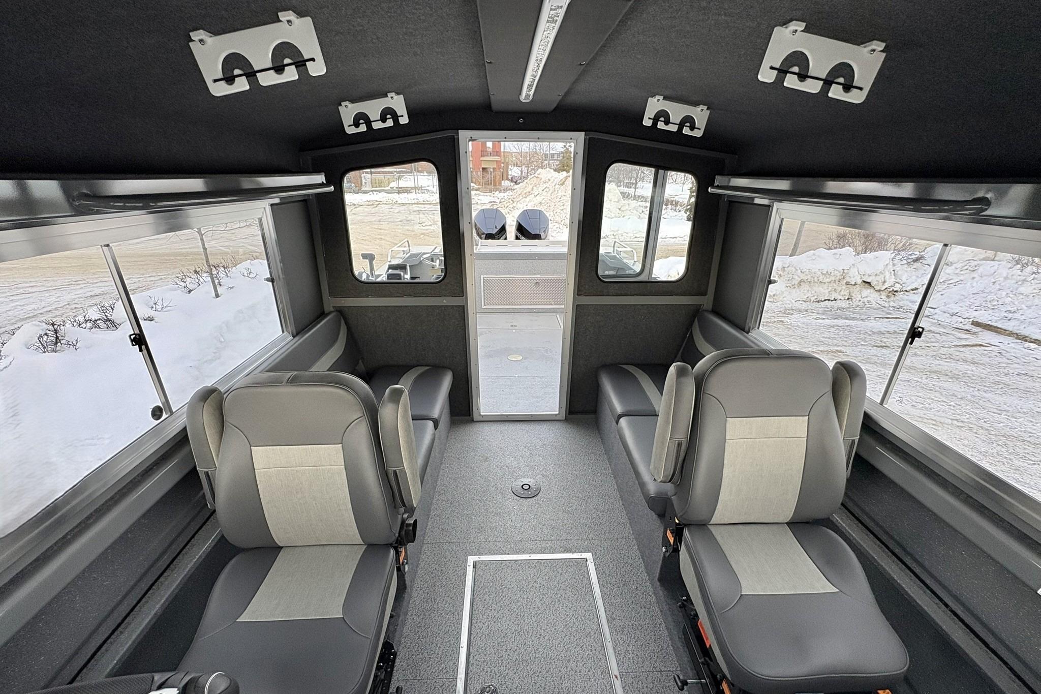 Interior of 2024 Spartan 26 Maximus Pro XL boat with seating and windows.