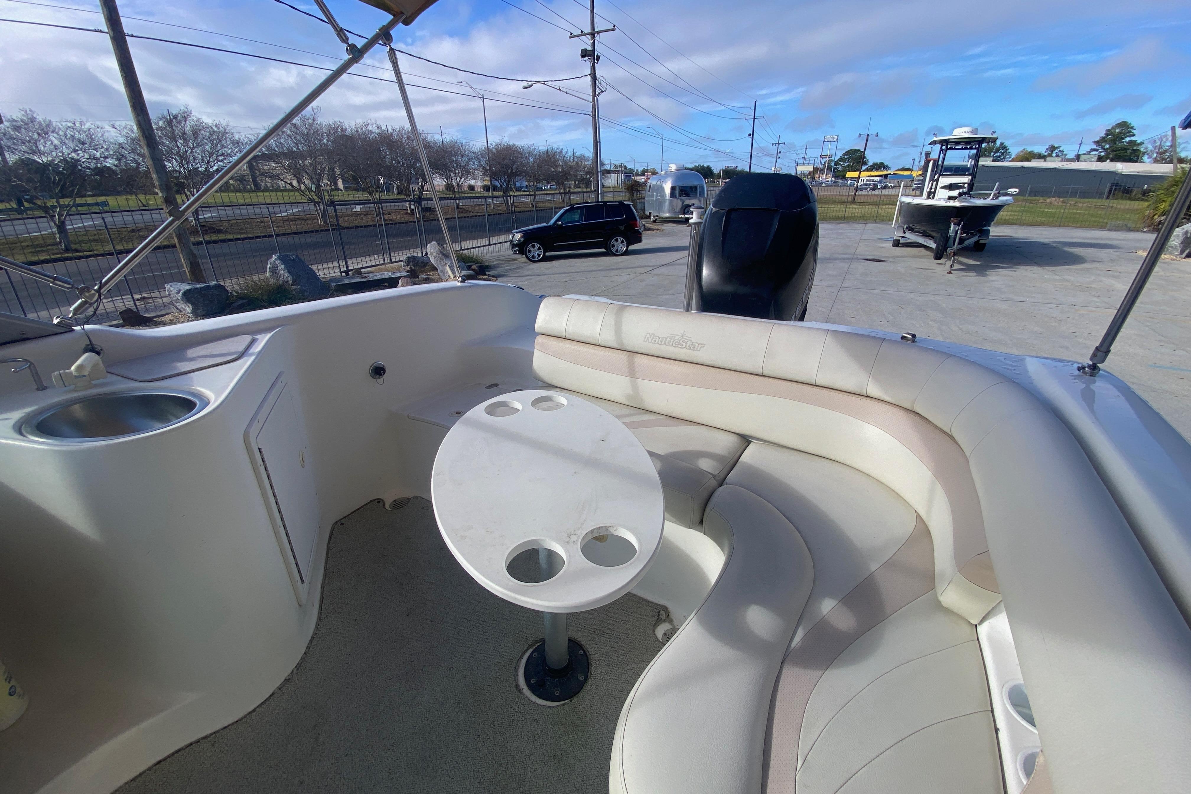 2007 NauticStar 230DC Sport Deck boat interior with seating and table.
