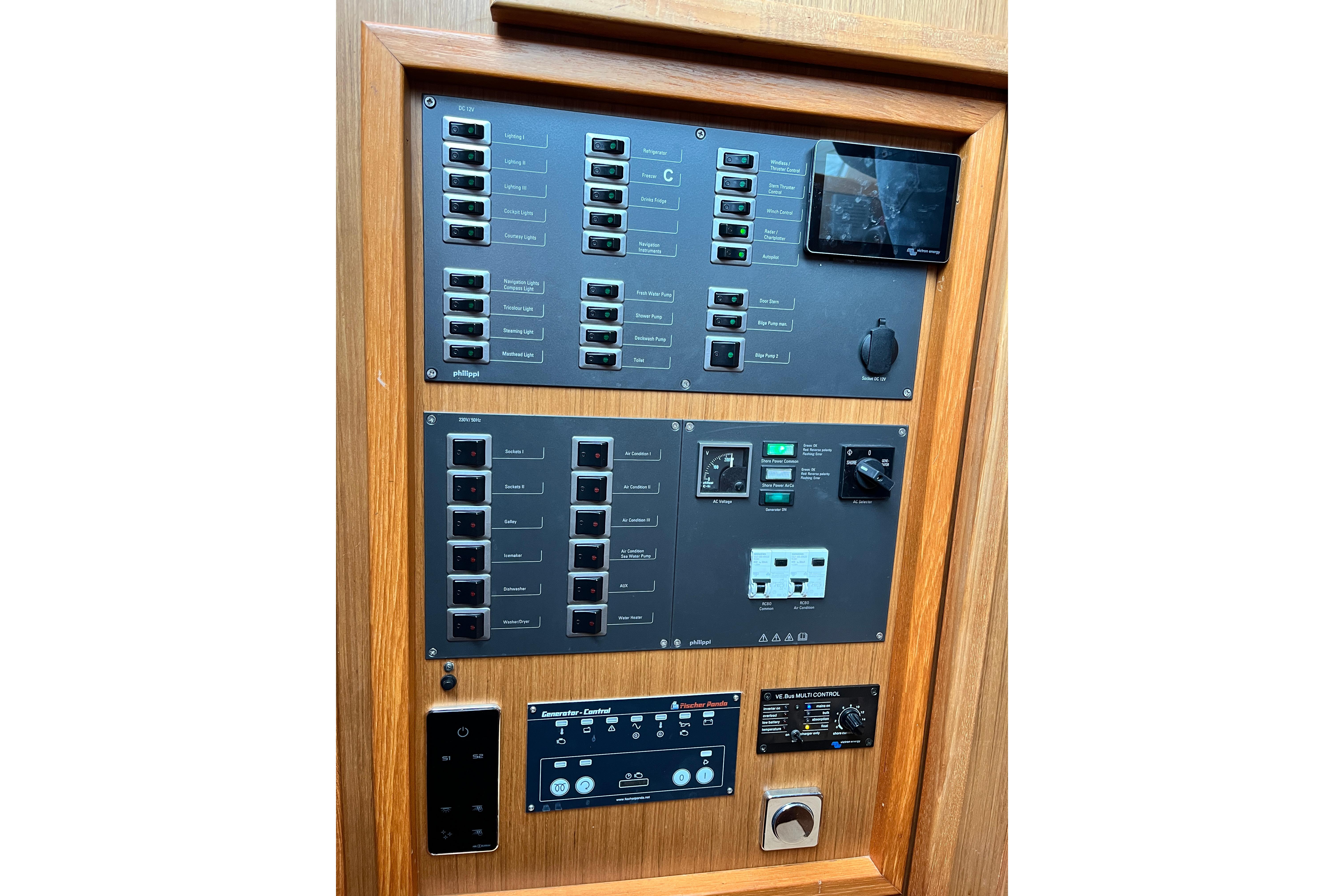 Electrical control panel on a 2012 Moody 45Ds yacht, featuring switches and outlets.