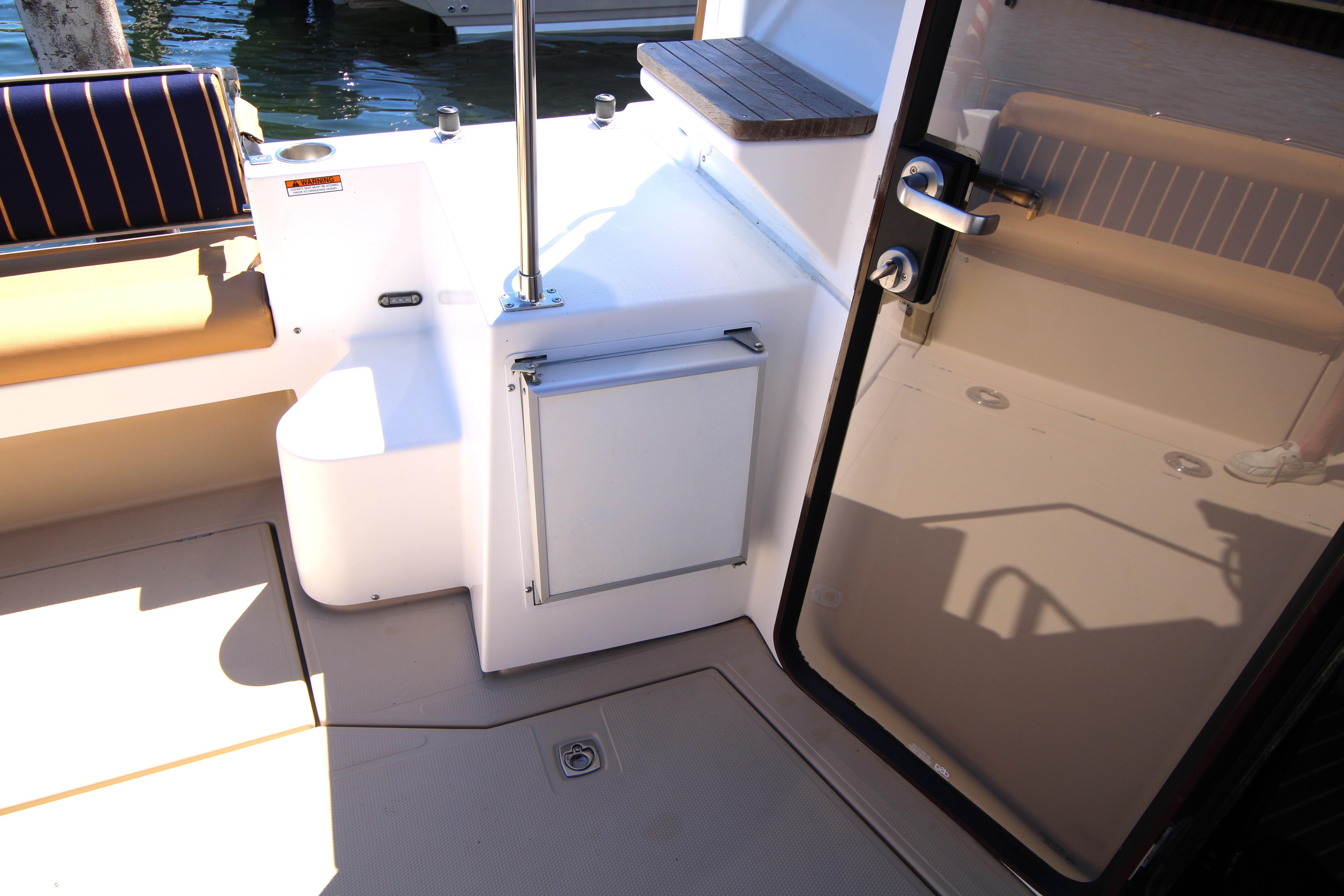 Interior view of 2013 Ranger Tugs R-31 CB boat, featuring seating and door details.