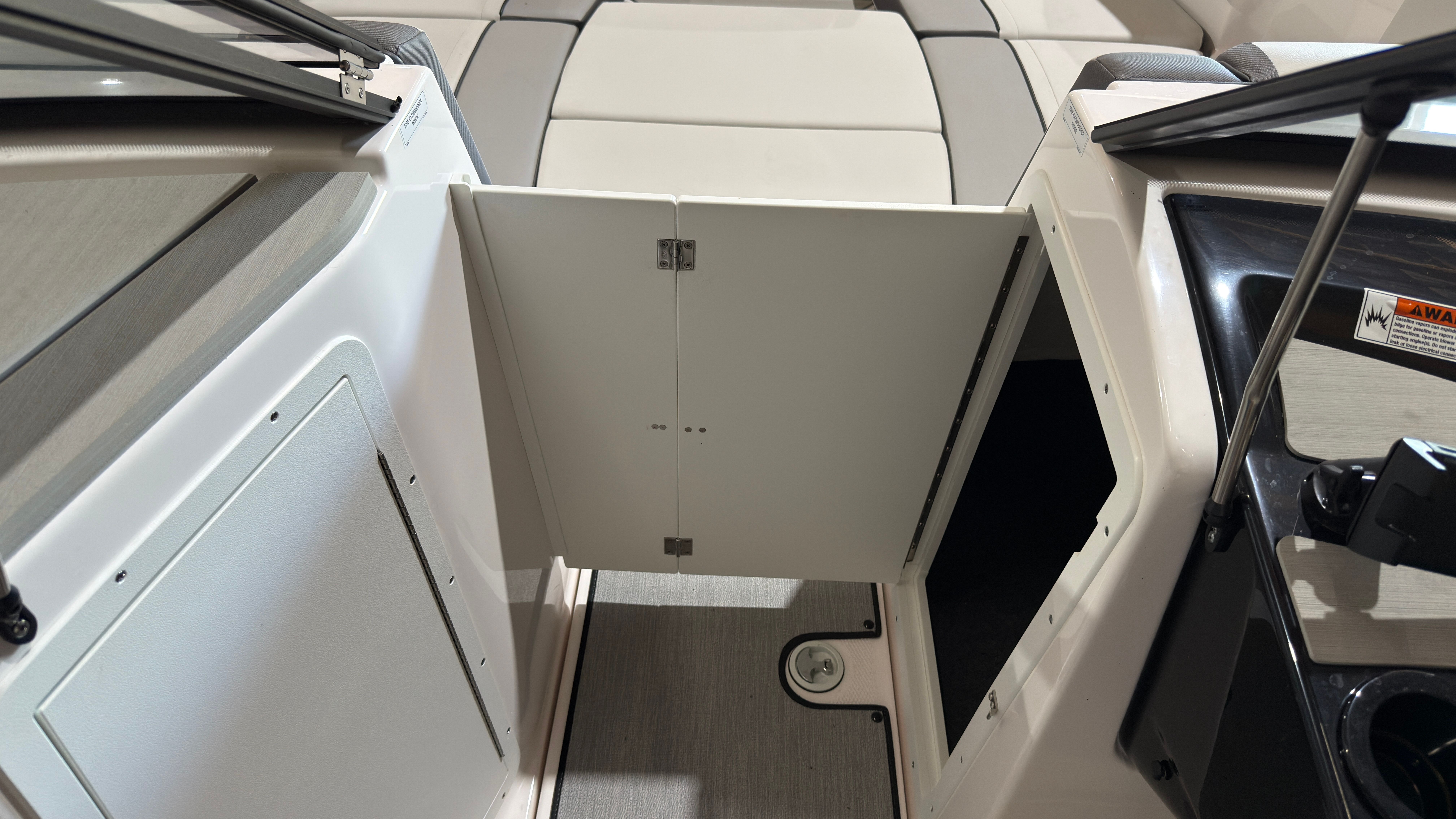 Interior of 2024 Yamaha Boats AR220 with storage compartment.