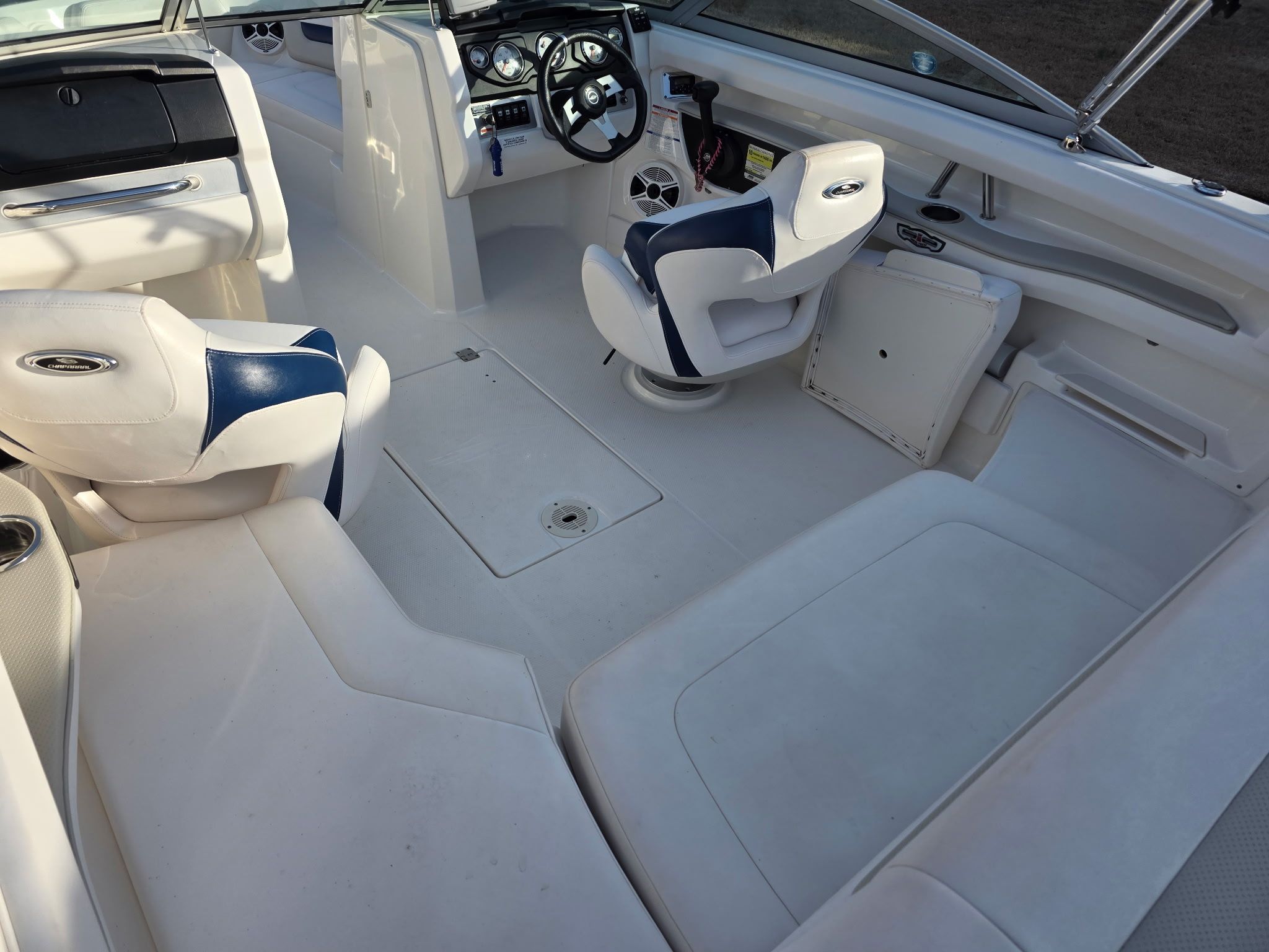 Interior of a Chaparral 206 SSi boat with white and blue seating.
