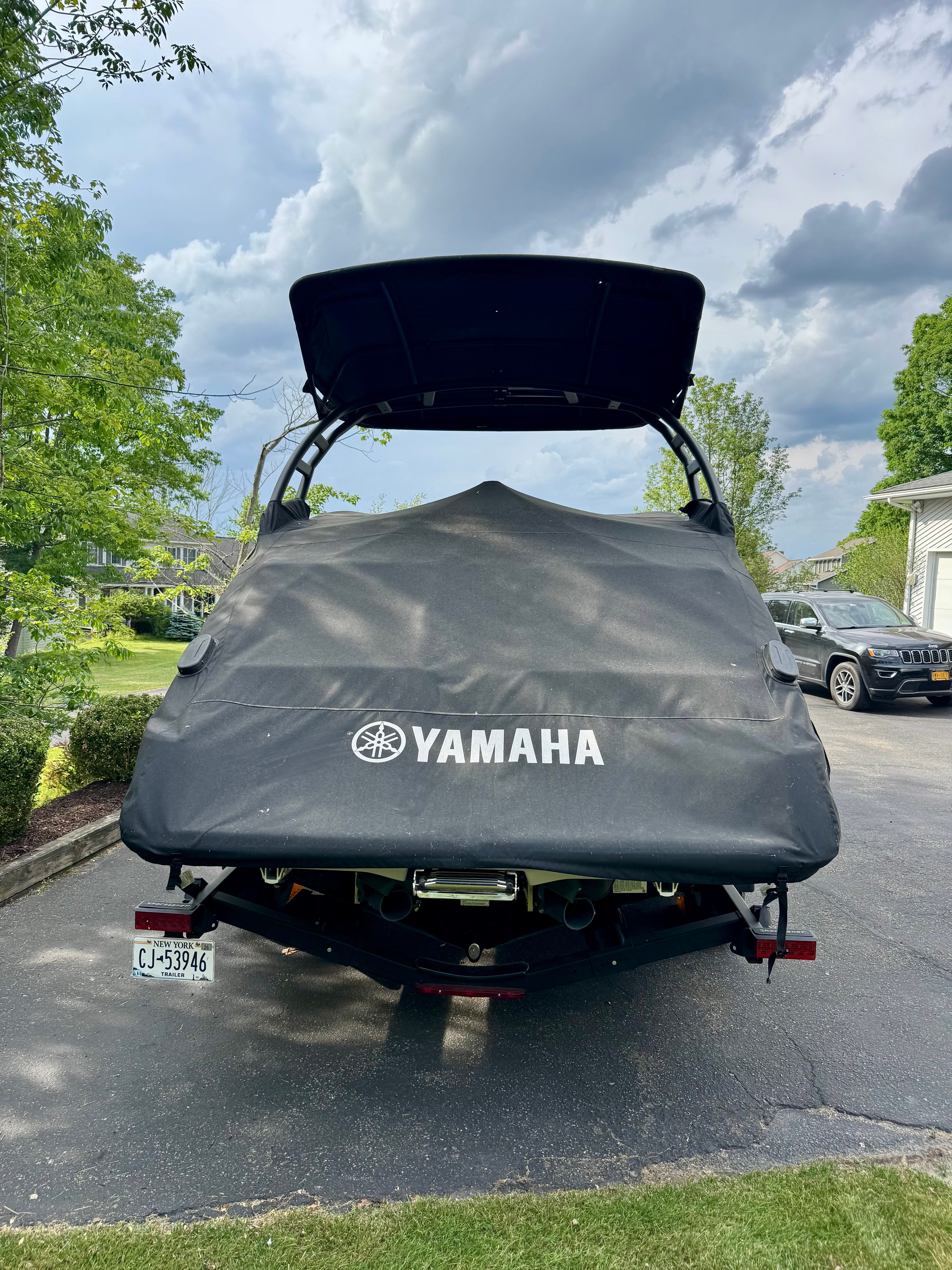 2025 Yamaha 252SD boat covered and parked in driveway.