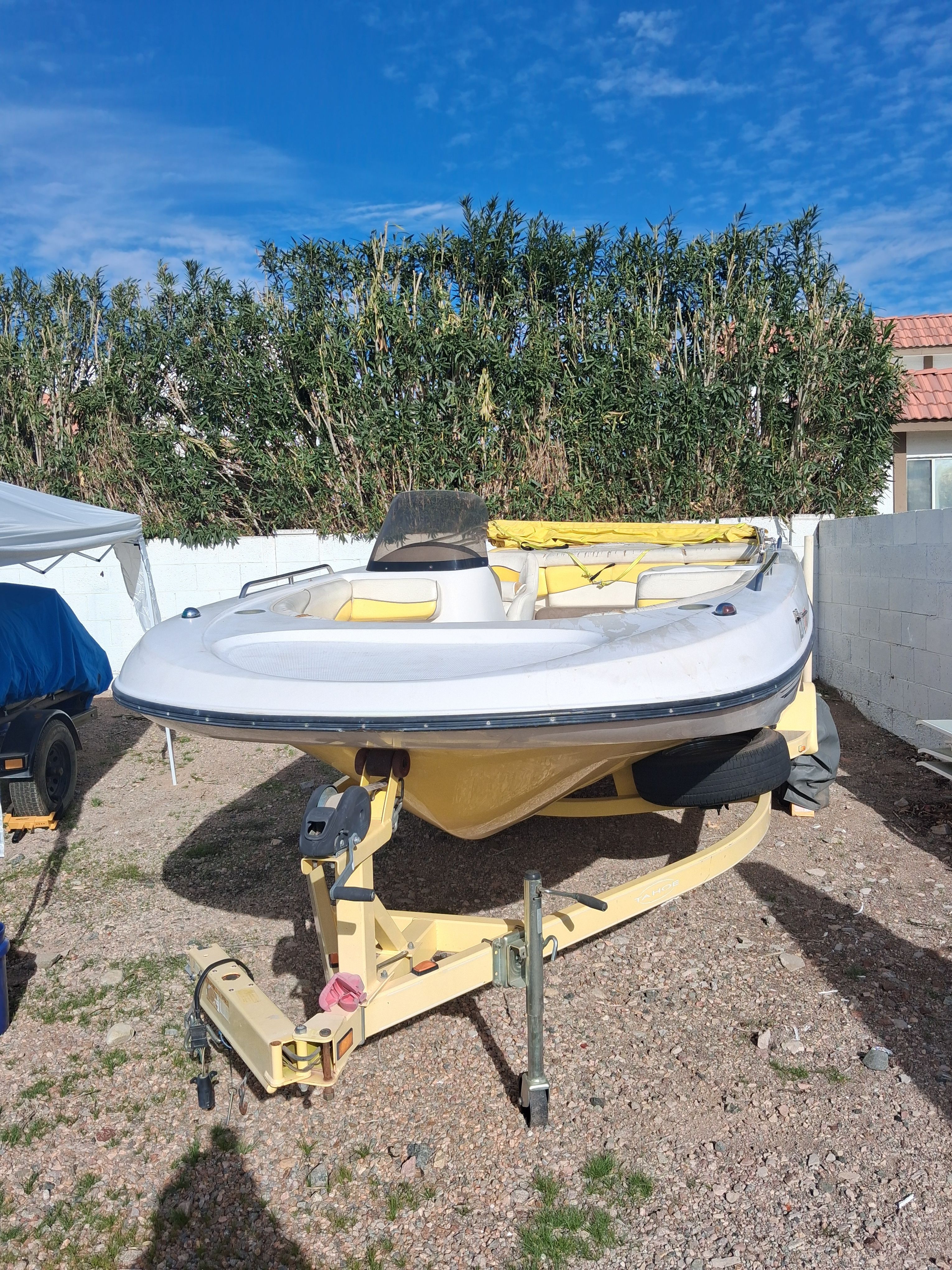 2004 Tracker Tahoe boat parked on trailer outdoors.