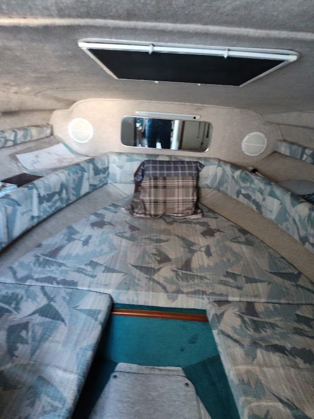 Interior of a 1994 Sea Ray 230 Sundancer with seating area.
