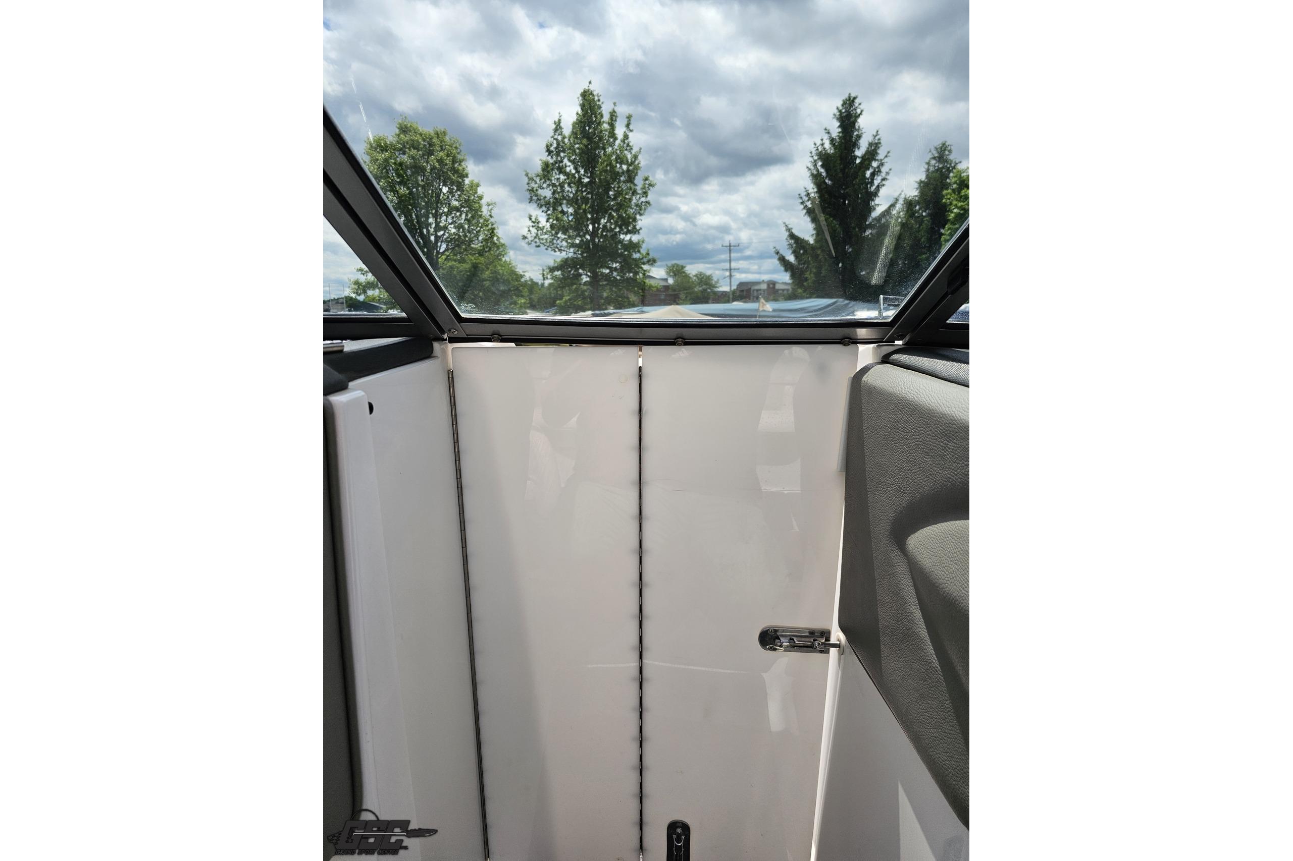 Interior view of a 2010 Cobalt 232 WSS boat with closed cabin door.