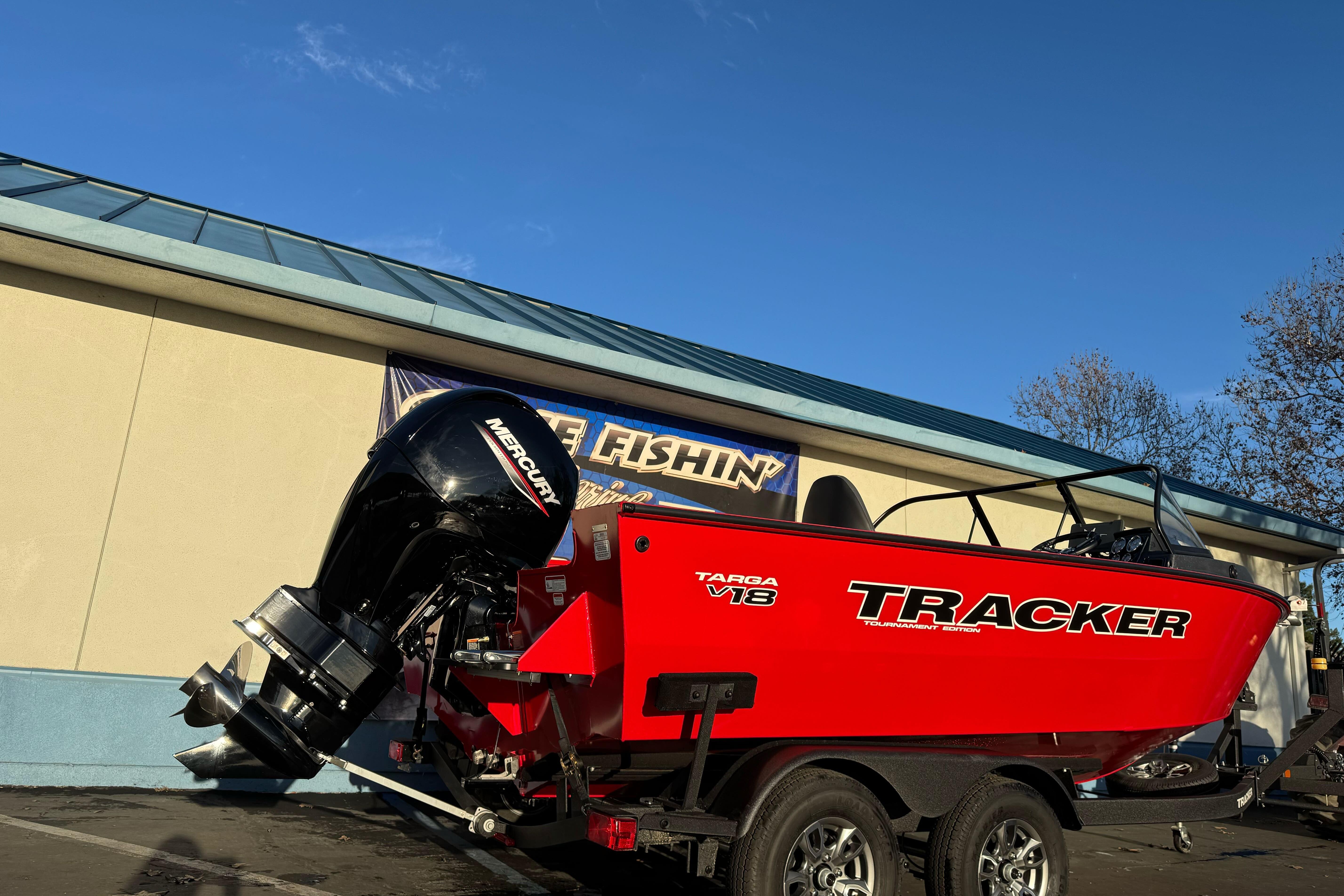 2026 Tracker Targa V-18 WT boat with Mercury engine on trailer, parked outdoors.